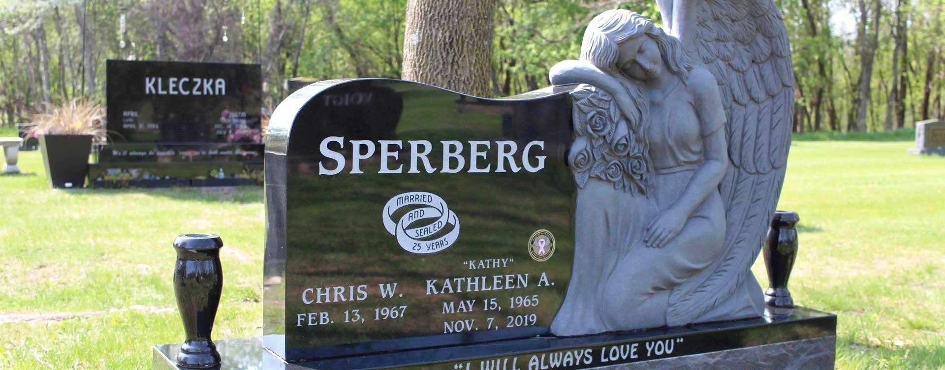 A black and gray granite tombstone