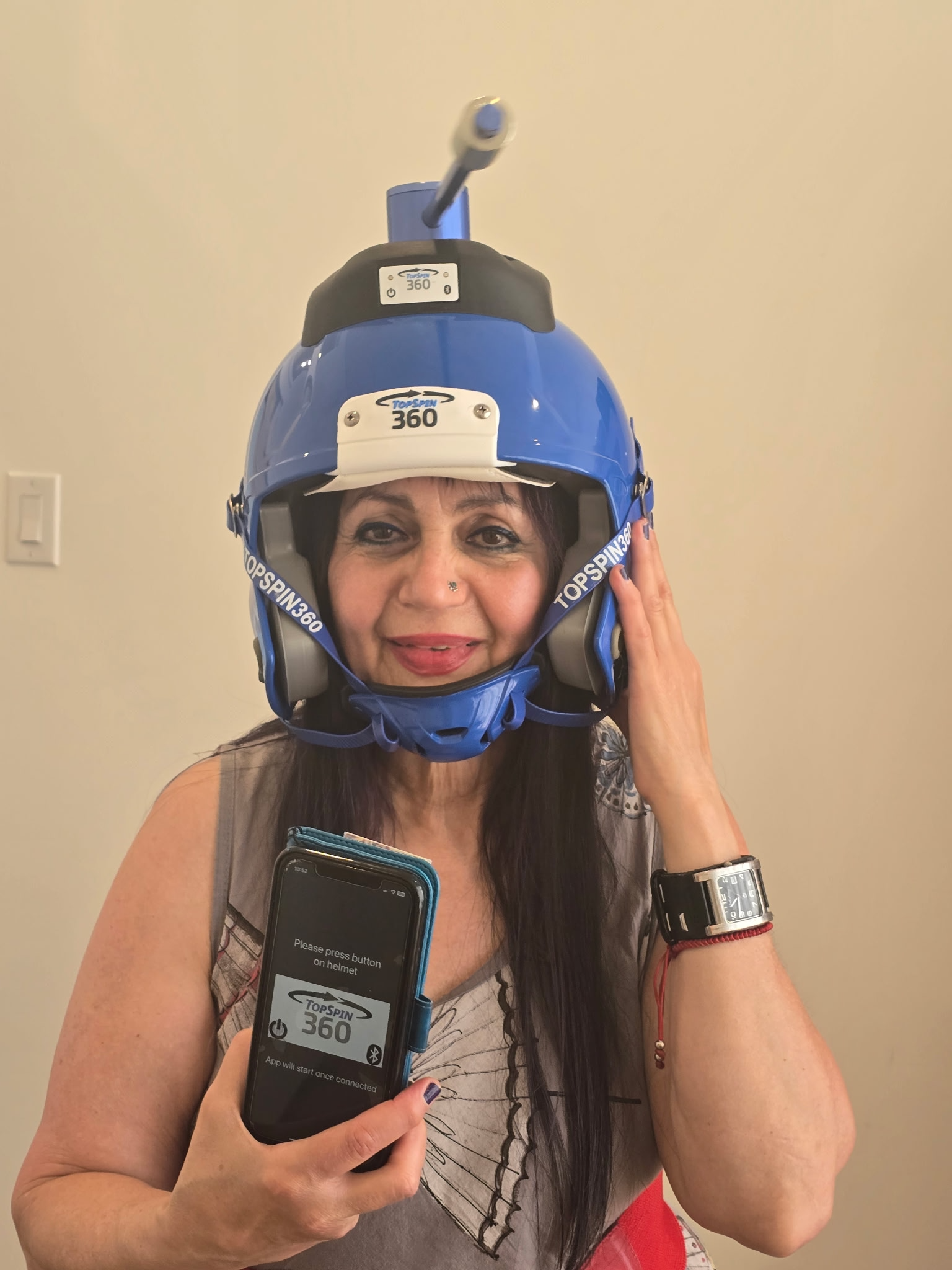 Dr. Nina Petrie wearing the TopSpin360 neck-training helmet used in concussion and whiplash recovery
