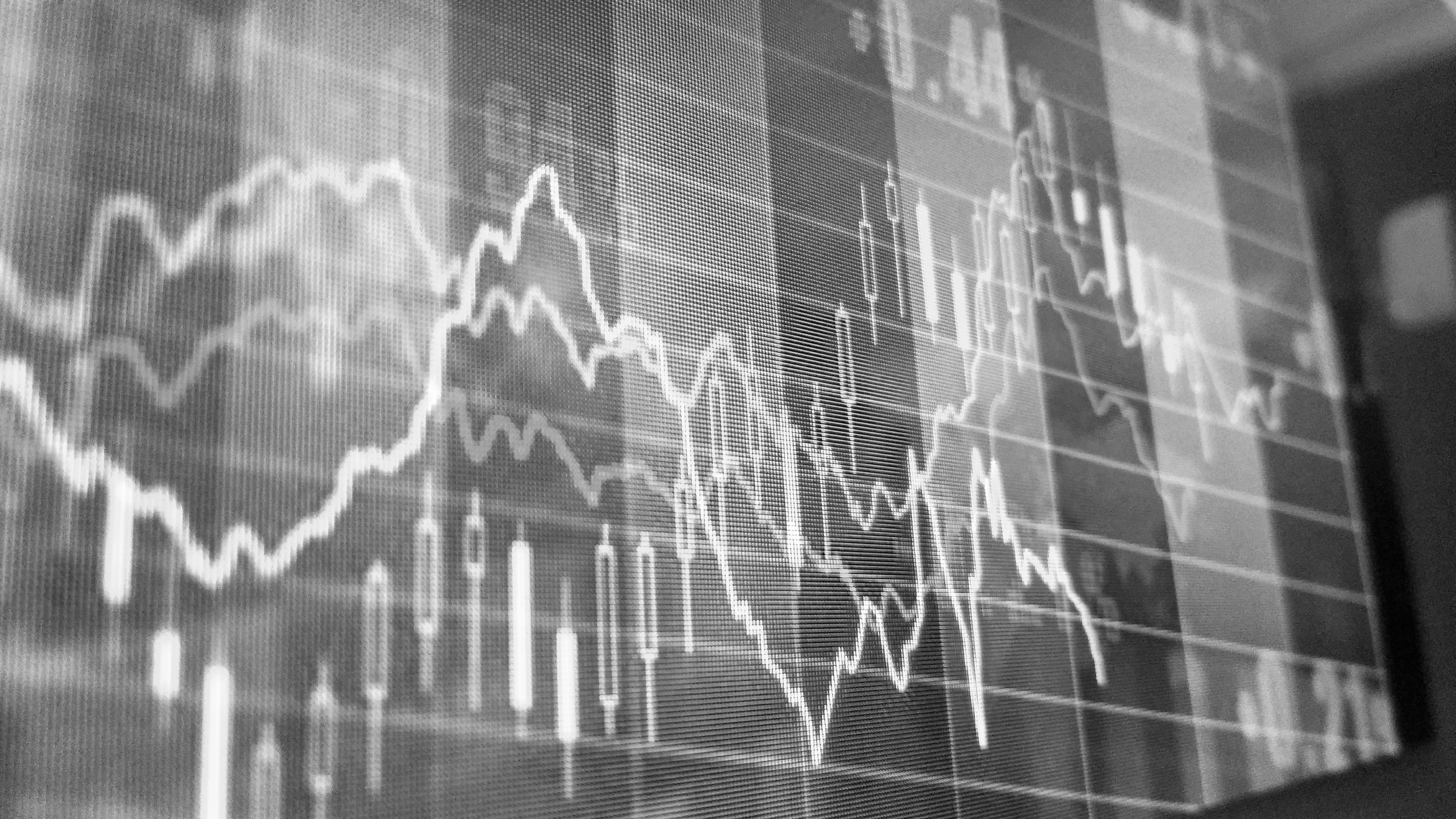 Financial or stock market charts with fluctuating graph lines.