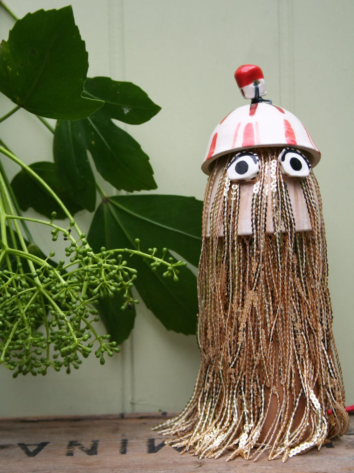 ceramic Christmas tree topper creature with gold fringing and big eyes cute bobble hat interior design festive