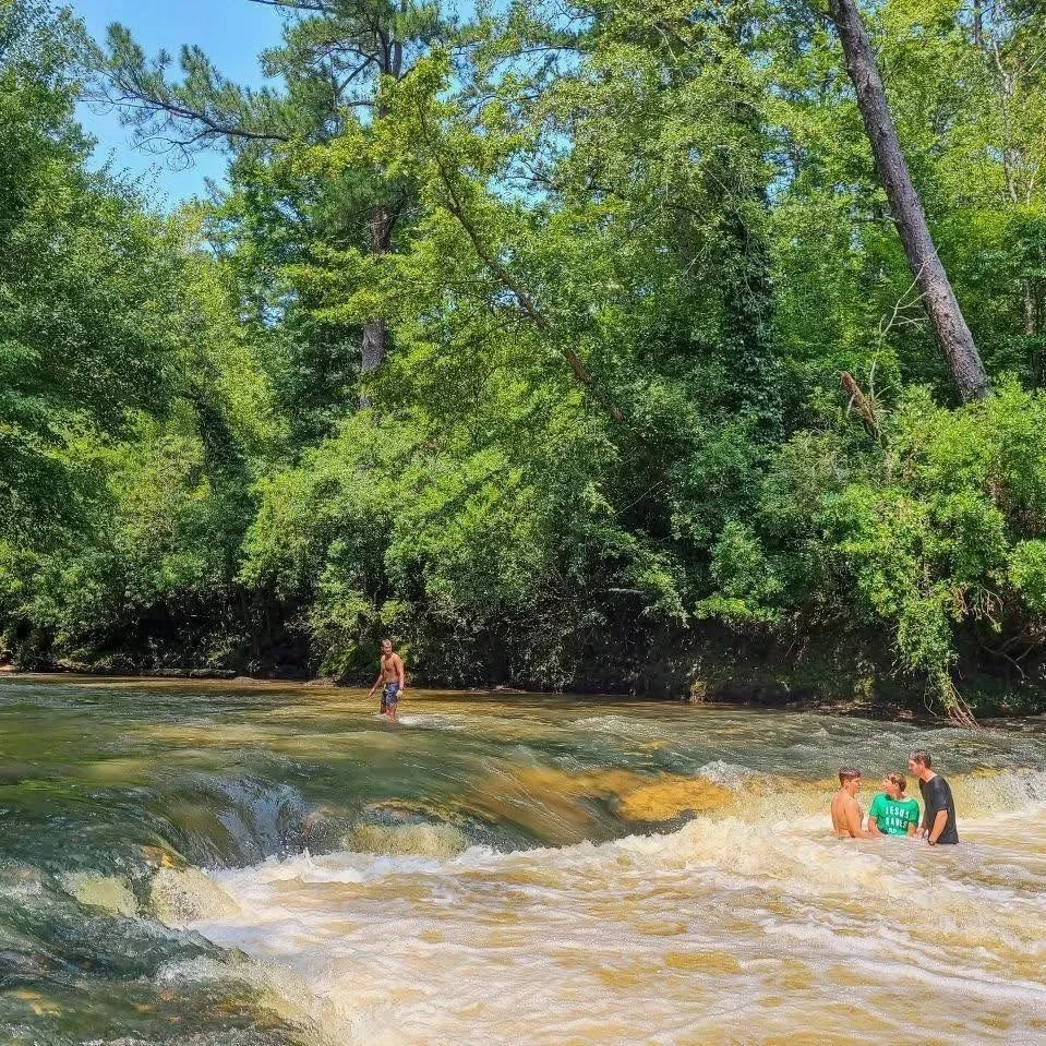 Kids playing in the Okatoma Creek in Seminary, MS on a sunny day