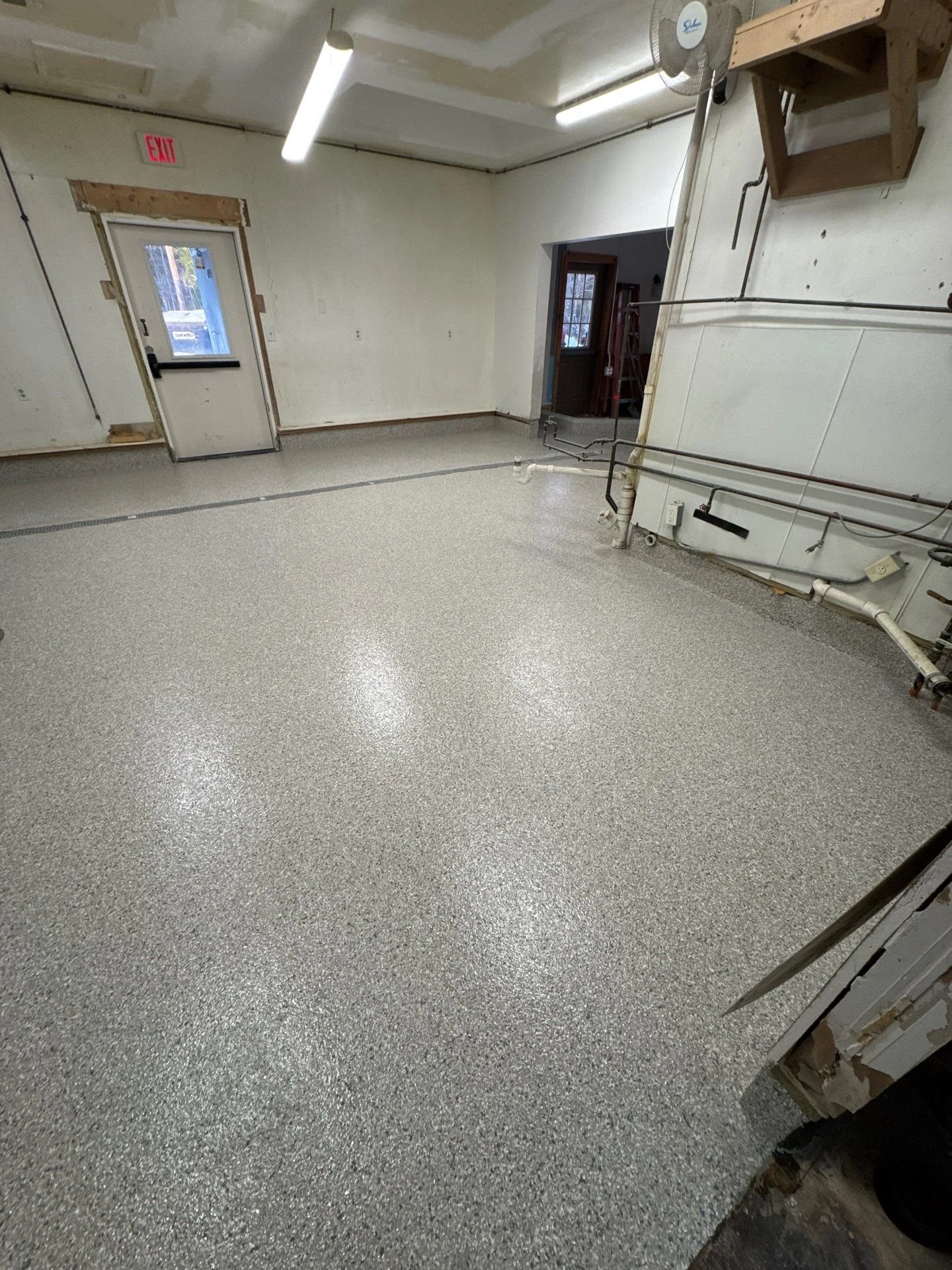 Empty industrial kitchen with a speckled epoxy floor