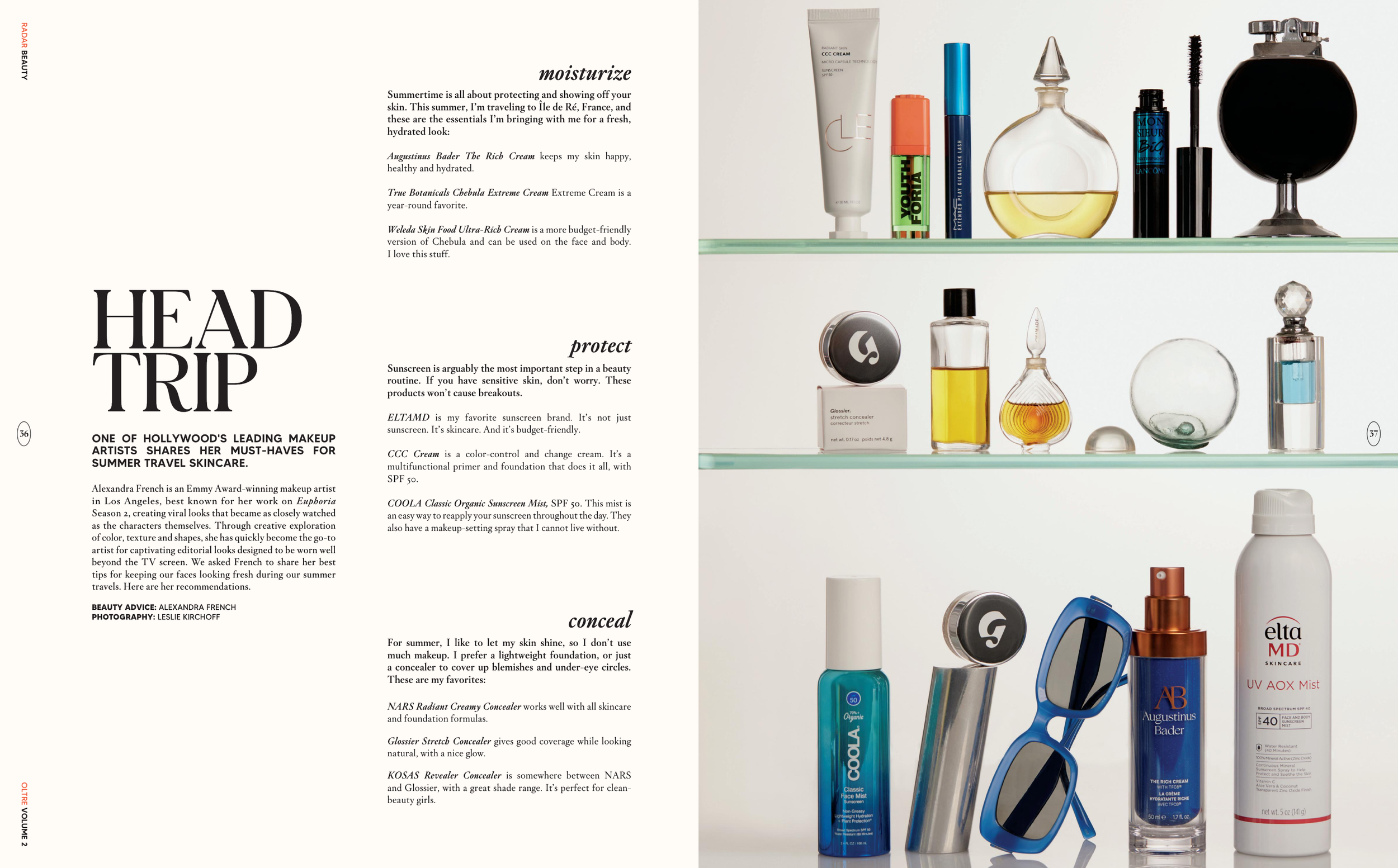 Several beauty and skincare products arranged on glass shelves, including tubes, bottles, jars, and a pair of blue sunglasses, with a background of white walls and part of a beauty magazine article.