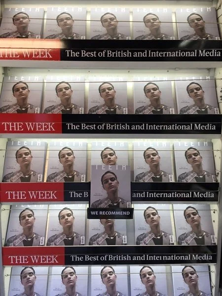 Display of magazines on a shelf featuring a model, with text for 'The Week' and 'The Best of British and International Media'.