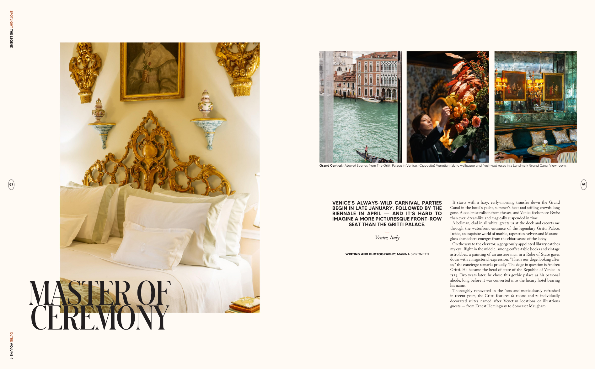 Interior of a luxurious bedroom with a cream-colored wall, an ornate gold headboard, and gold-framed artwork with decorative wall sculptures above. The bed has white linens and multiple pillows.