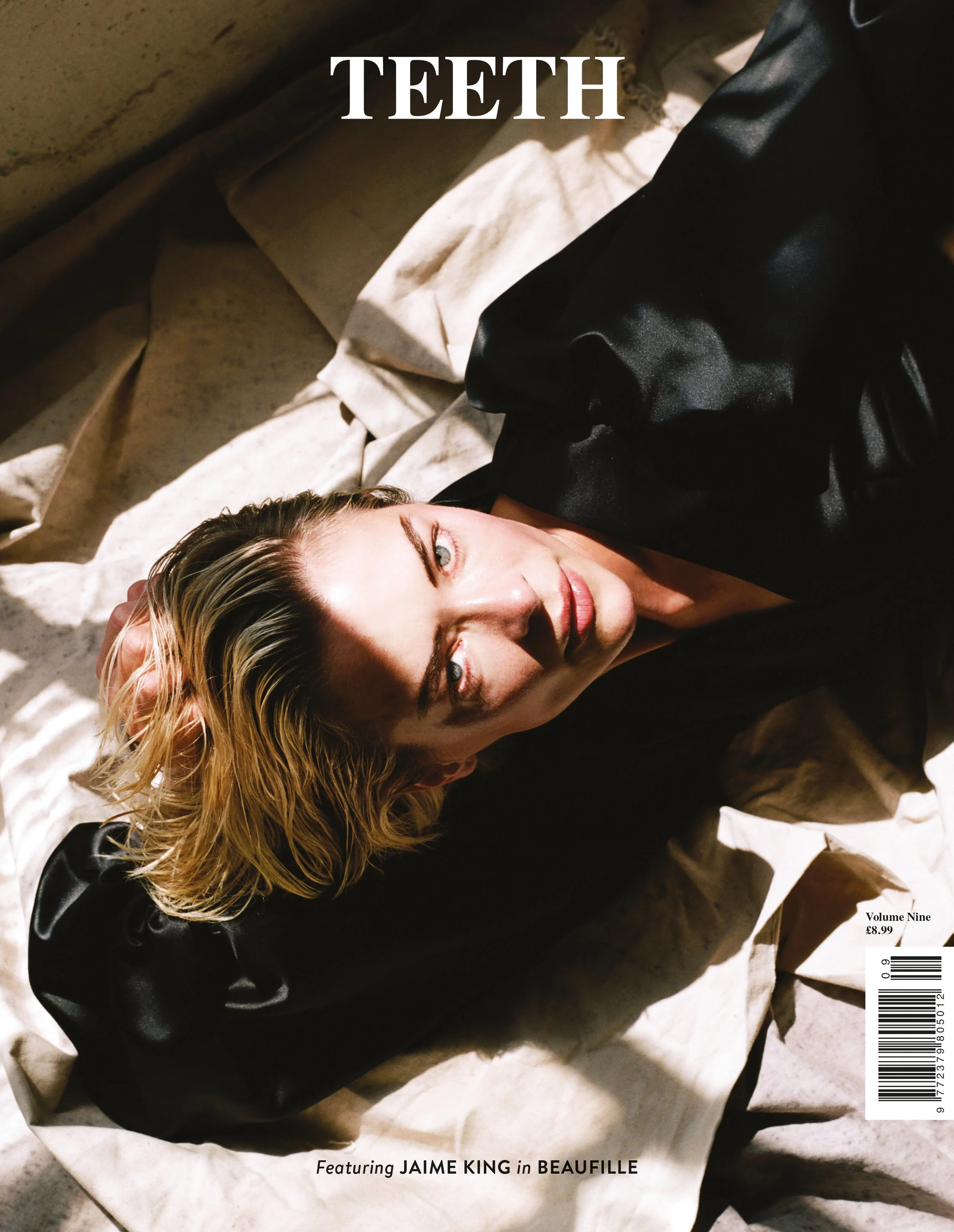 Magazine cover with a woman lying on the floor, with blond hair, wearing a black satin top and beige pants, and a black shoe visible. The title 'TEETH' is at the top, and the magazine features Jaime King in Beaufille, with the issue being Volume Nine
