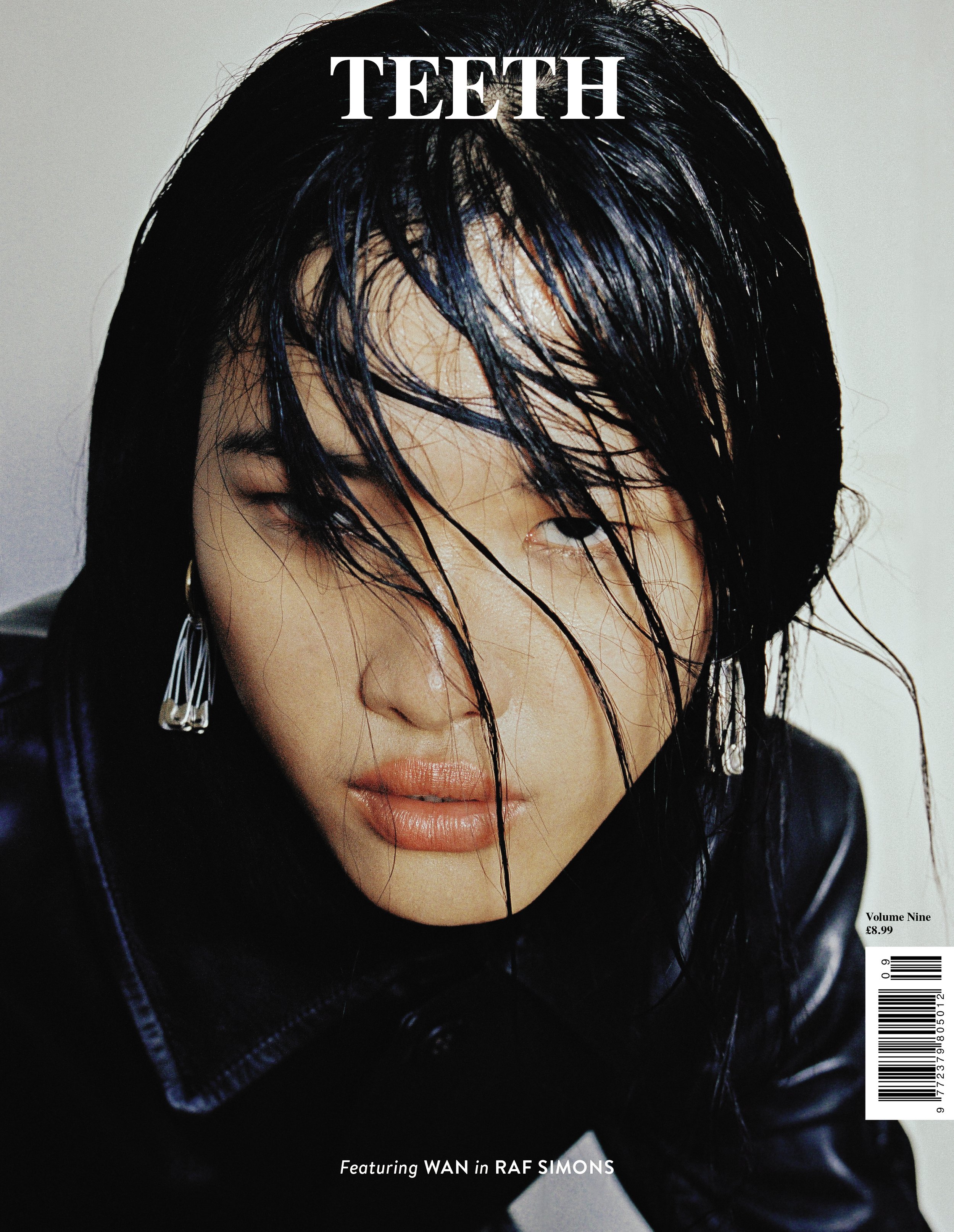 Close-up of a woman's face with wet black hair covering part of her face, slightly parted lips, wearing a black jacket with a zipper, and a silver earring on her visible ear. The magazine cover text reads 'TEETH' at the top, with additional text indi