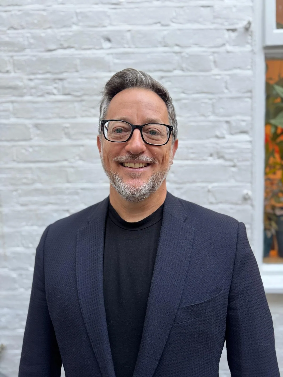 Michael Weber co founder smoke point partners head shot against white brick