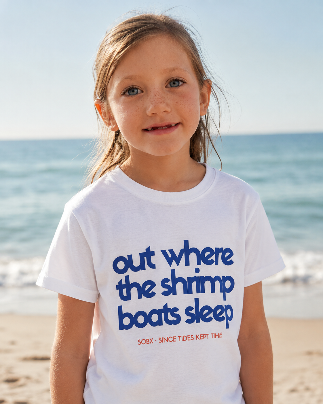 Young girl at the beach wearing "out where the shrimp boats sleep'  t shirt