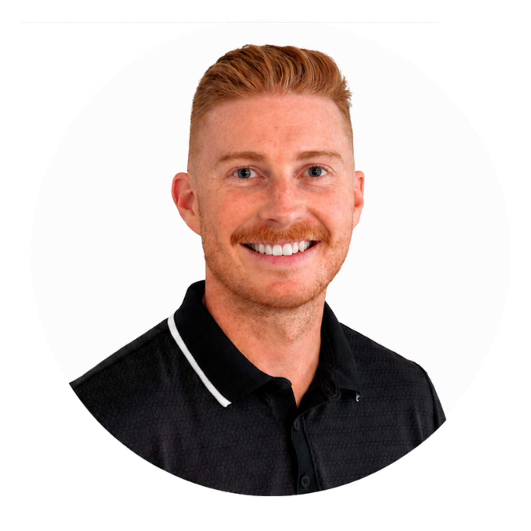 Portrait of a smiling man with red hair and a beard wearing a black shirt with a white collar