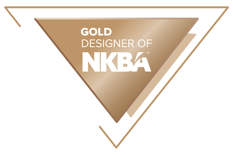 Gold-colored award plaque with a triangular shape and the words "GOLD DESIGNER OF NKBA" written on it.