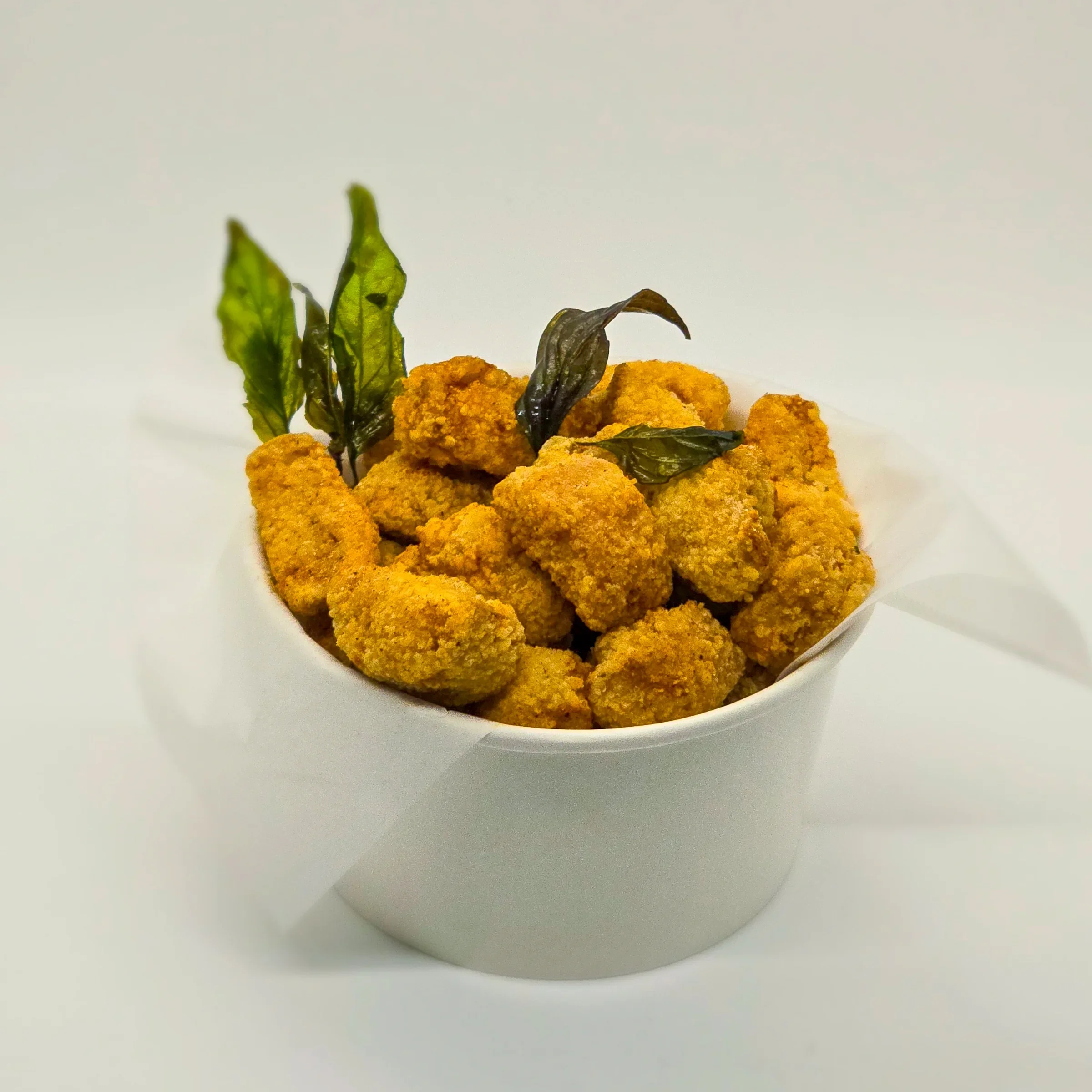 Popcorn king mushroom, juicy and fried to perfection. Topped with basil leaves.