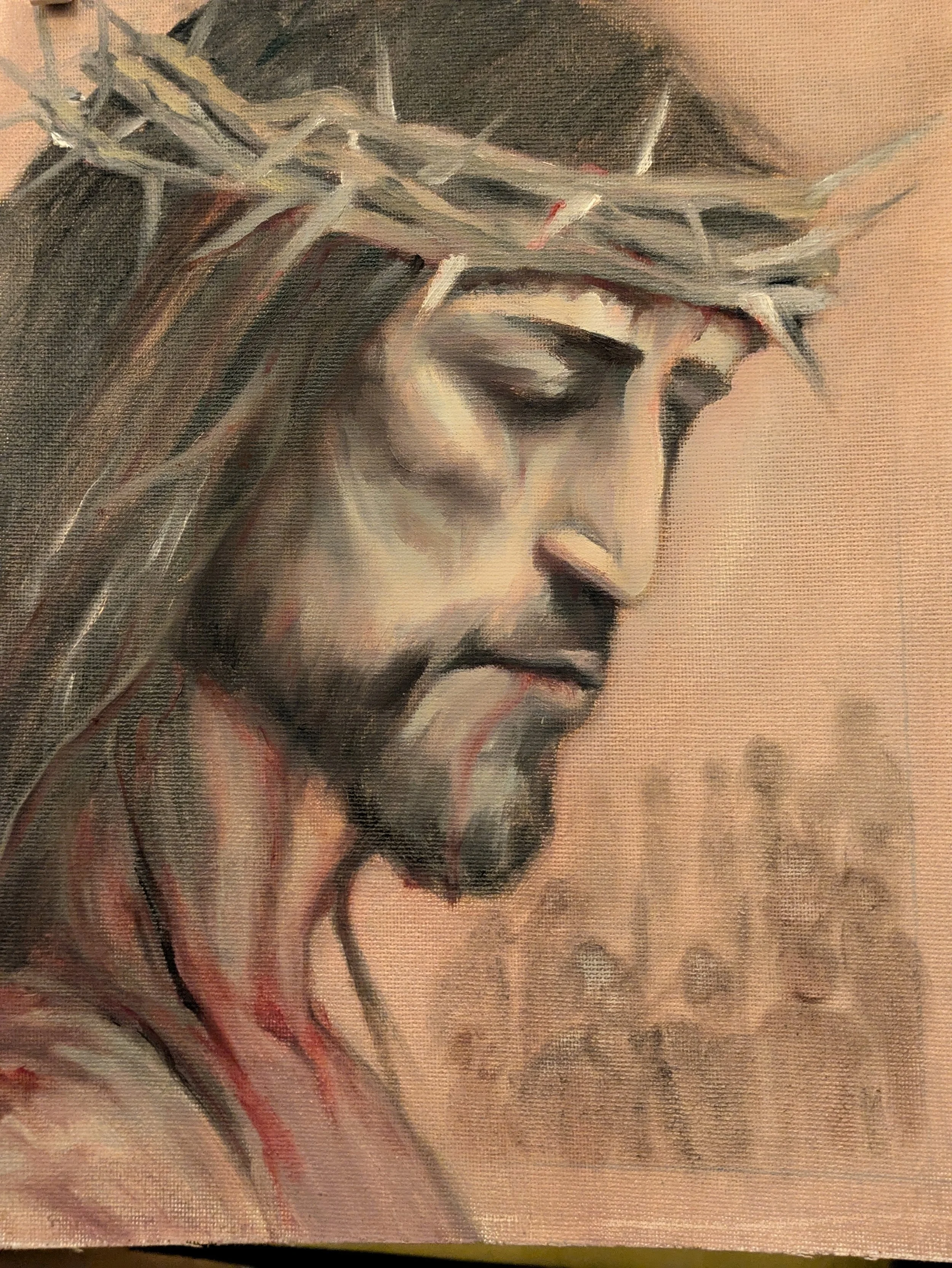 Close-up of a painting depicting Jesus Christ wearing a crown of thorns, His face is beaten and bruised, closed eyes, and visible blood on his face and neck with a crowd of witnesses in the background.