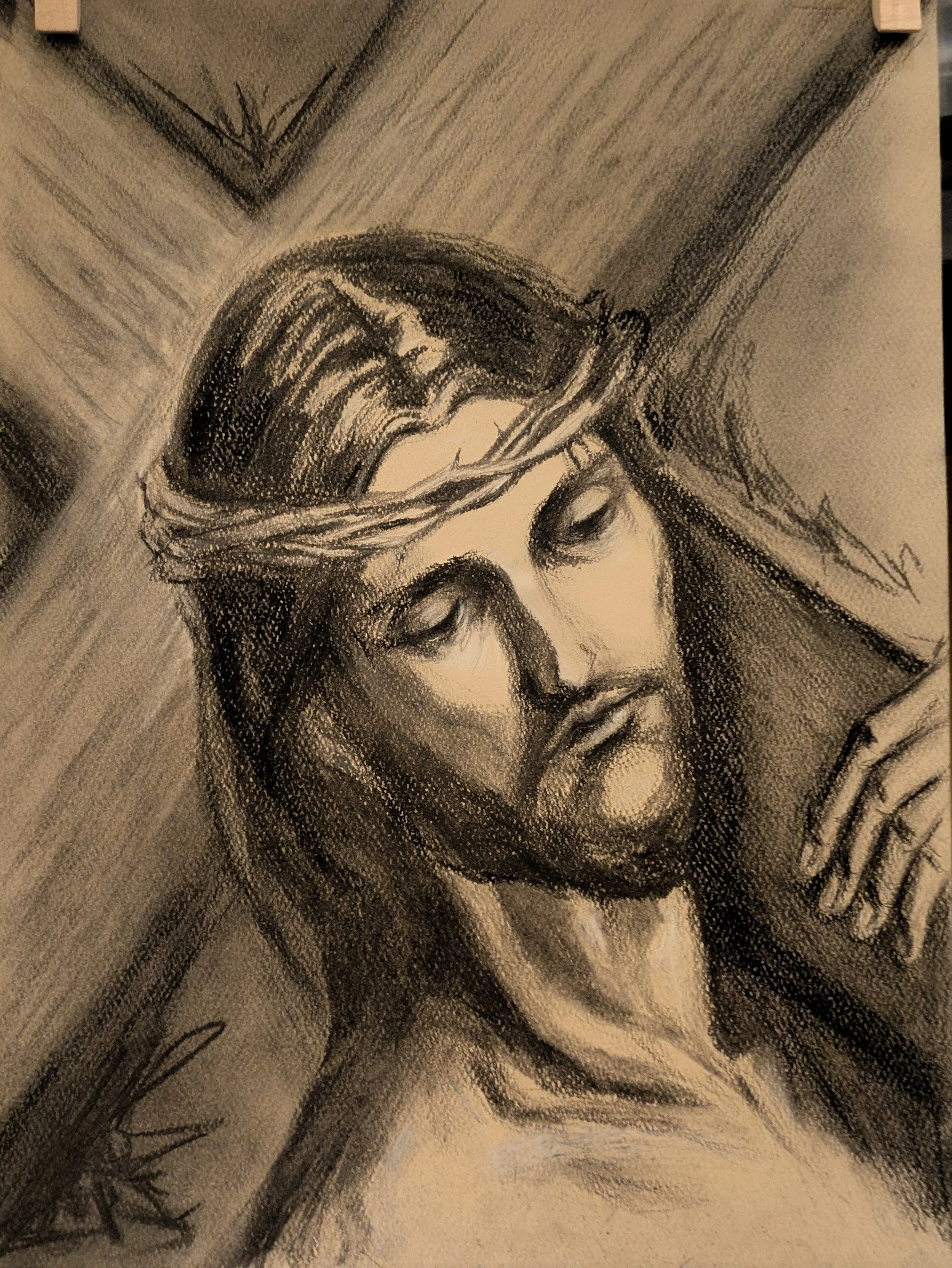 A charcoal of Jesus Christ carrying His cross.