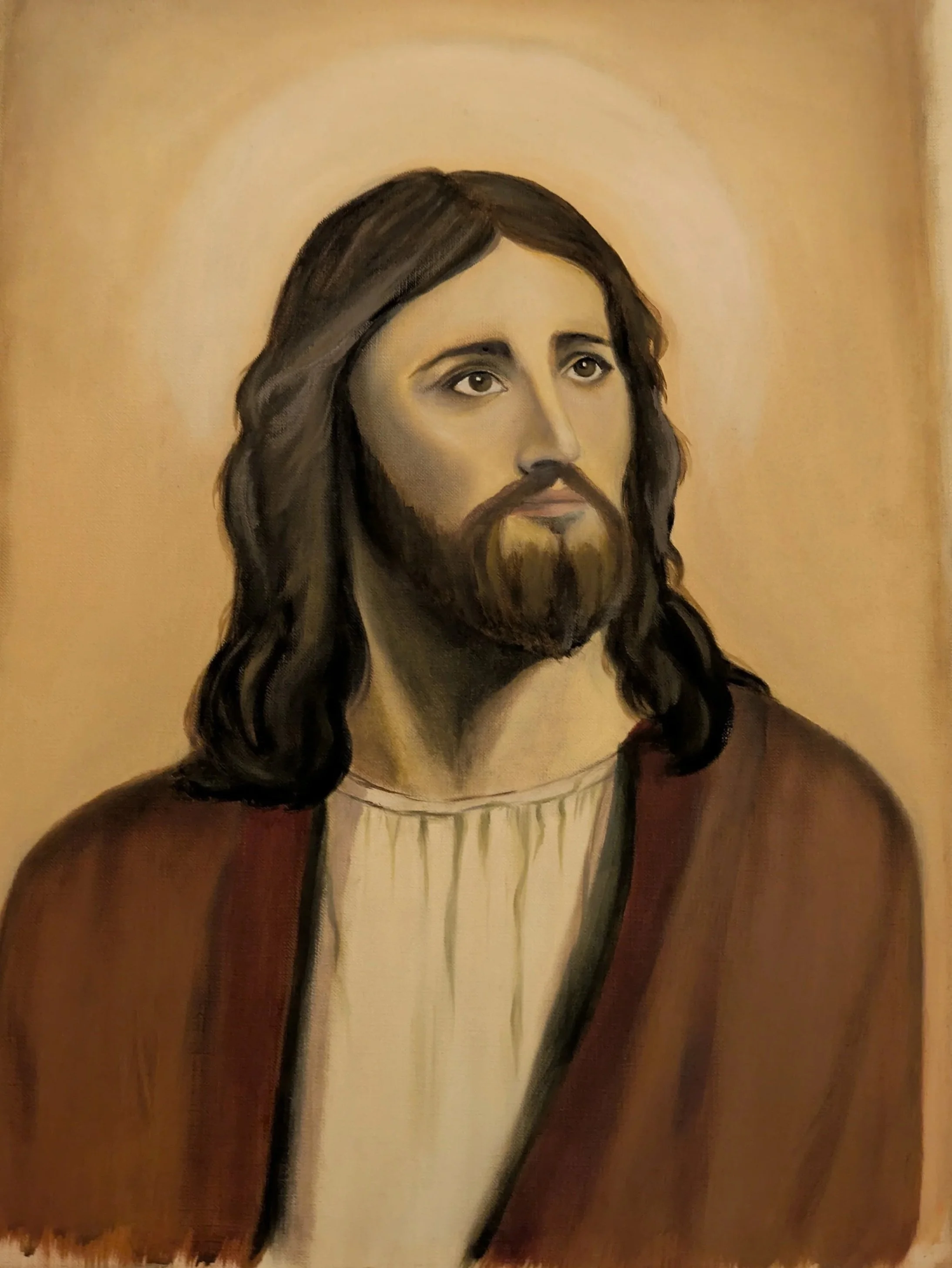 Painting of Jesus Christ with long dark hair, brown eyes, beard, and wearing a robe, depicted against a golden background.