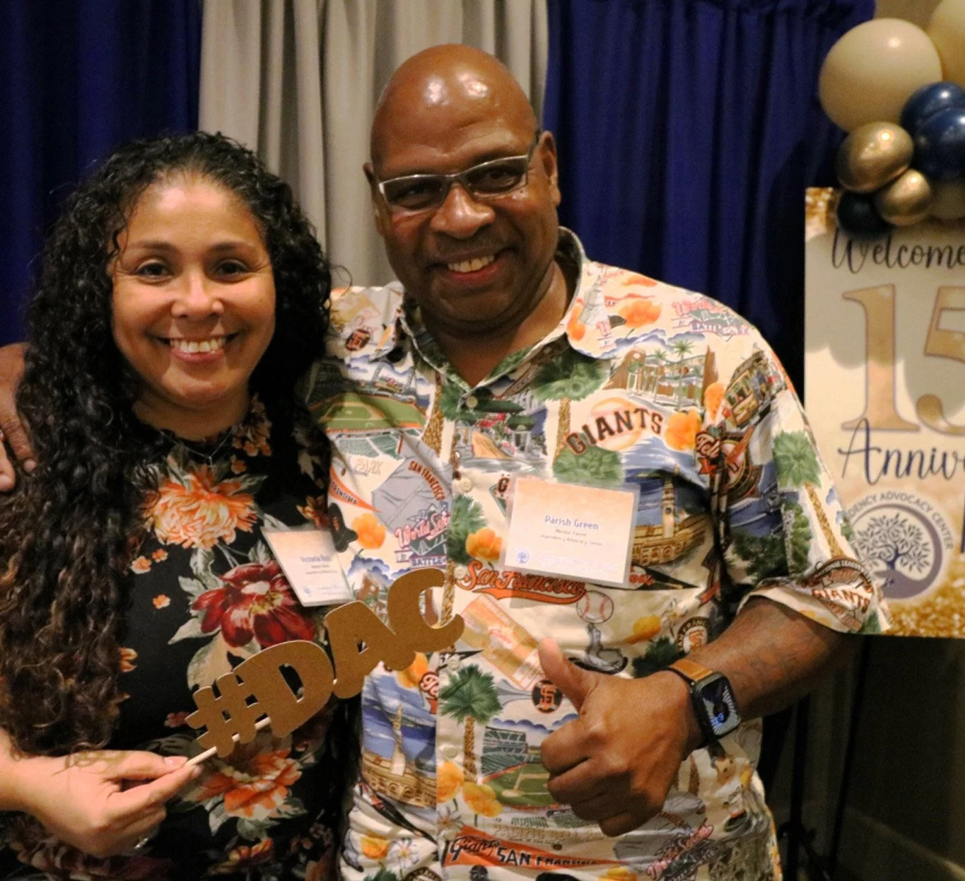 Two people smiling at DAC's 15th anniversary celebration.