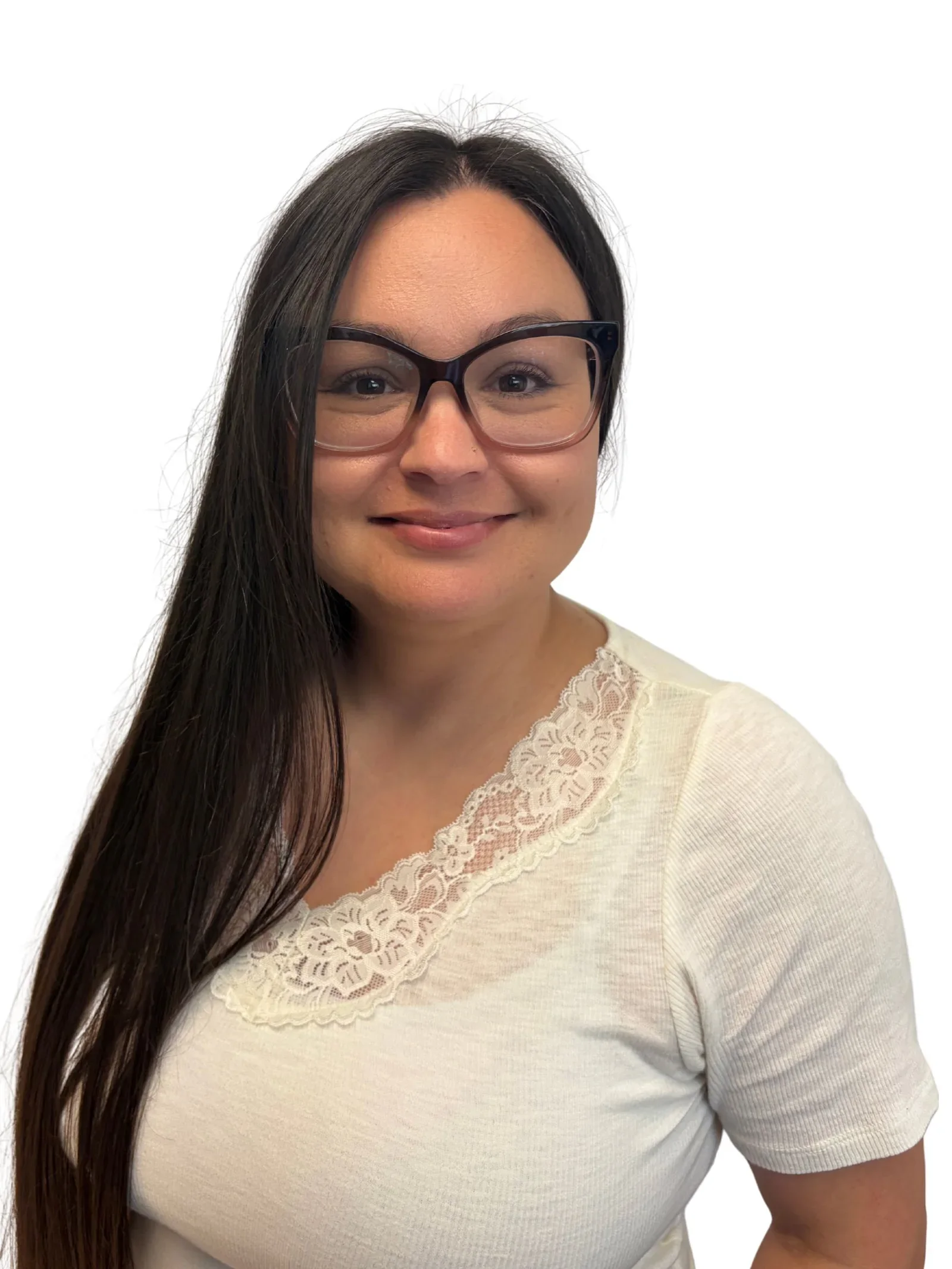 Close-up of a smiling woman with long dark hair wearing glasses and a cream-colored top with lace detailing on the neckline, against a white background.