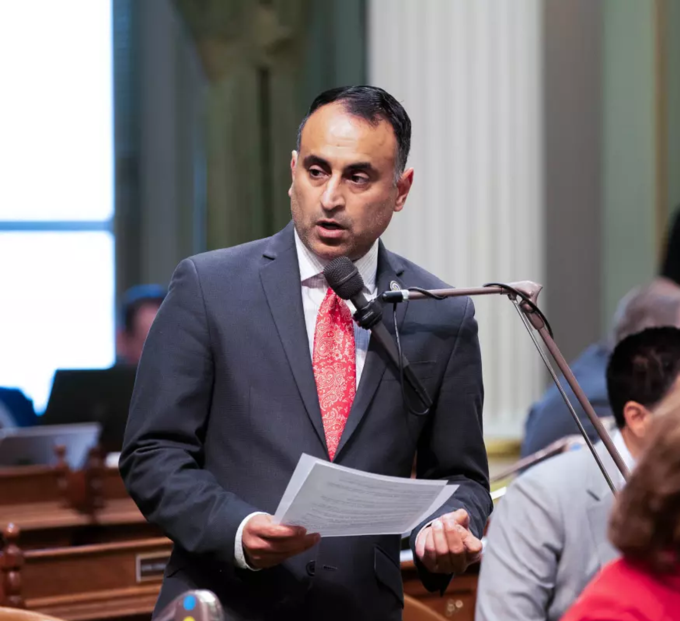 Assemblymember Ash Kalra speaking at a podium.
