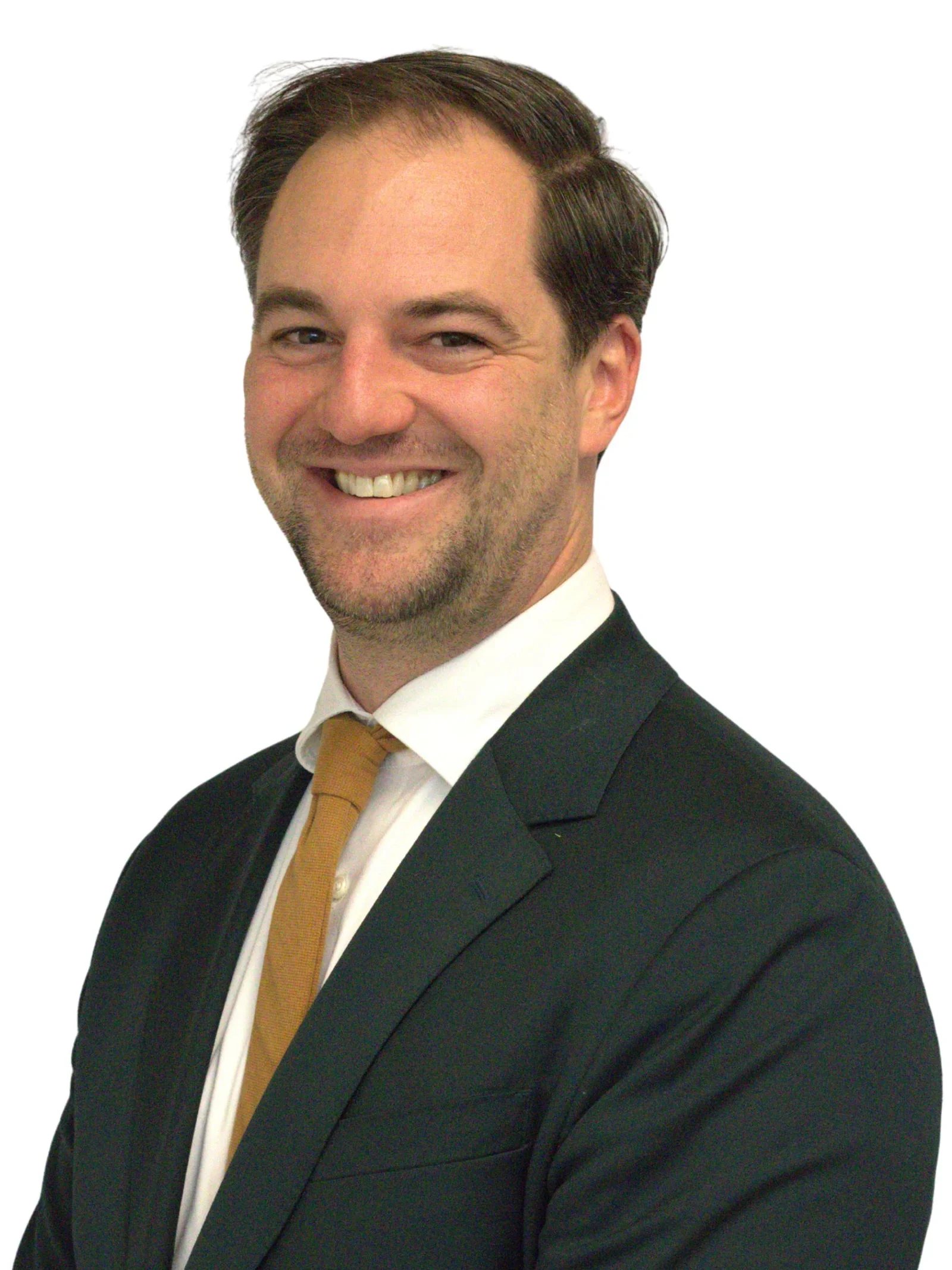 A smiling man with dark hair, wearing a suit, white shirt, and tan tie, against a plain white background.