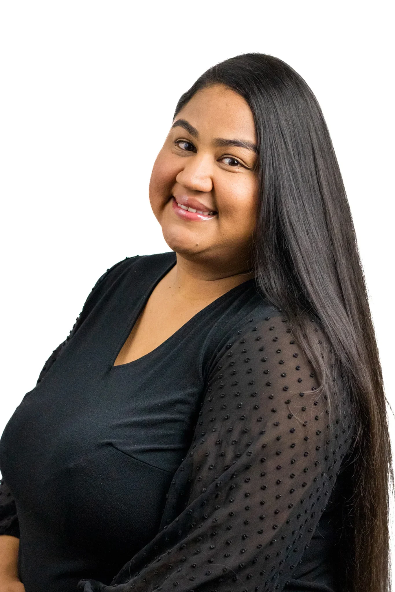 A woman with long, straight black hair smiling at the camera, wearing a black top with mesh sleeves.