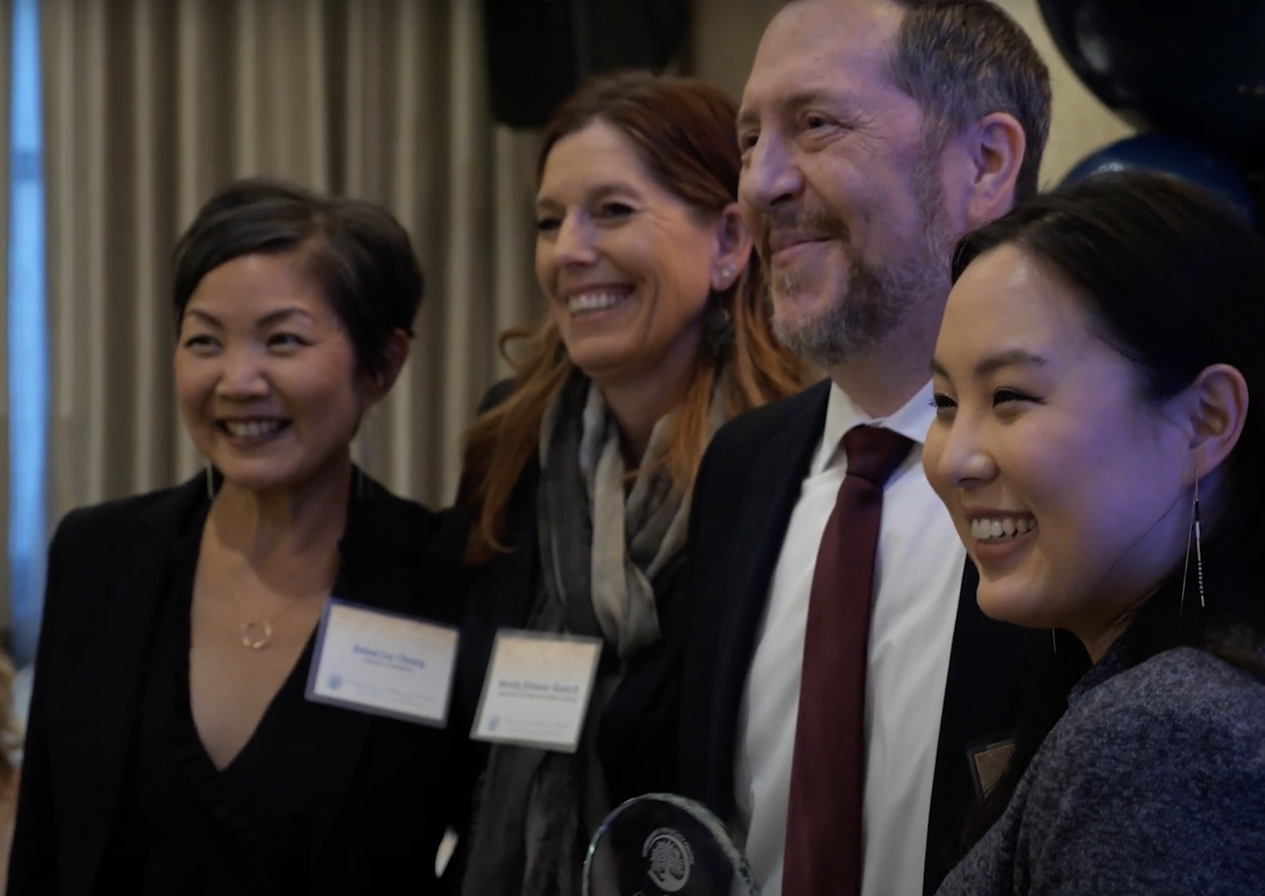 Four people smiling at DAC's 15th anniversary celebration.