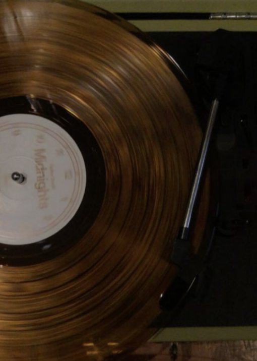 Close-up of a spinning vintage vinyl record on a turntable.