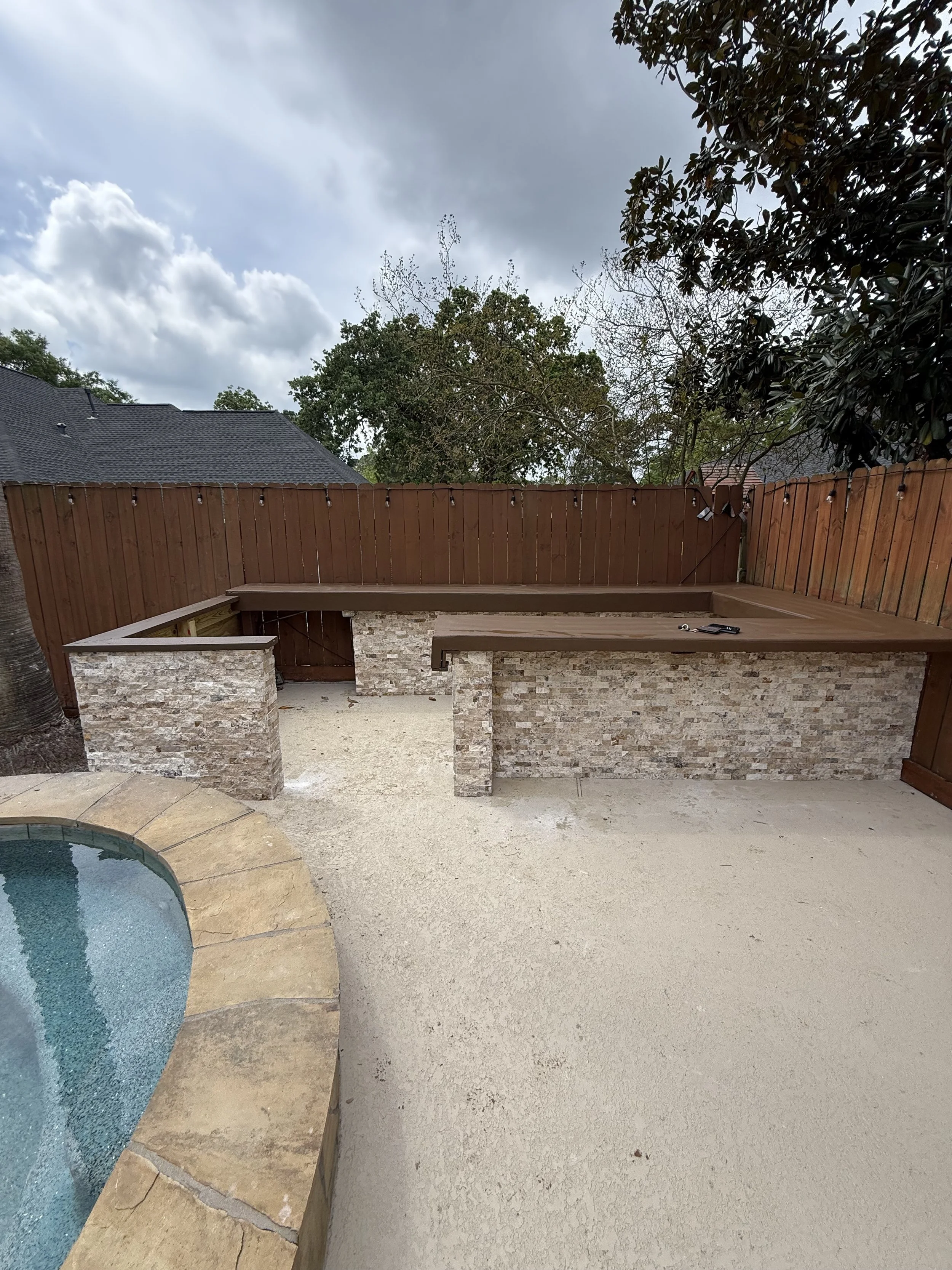 Outdoor custom tile installation around pool area in Greater Houston by Prestige Tile Solutions