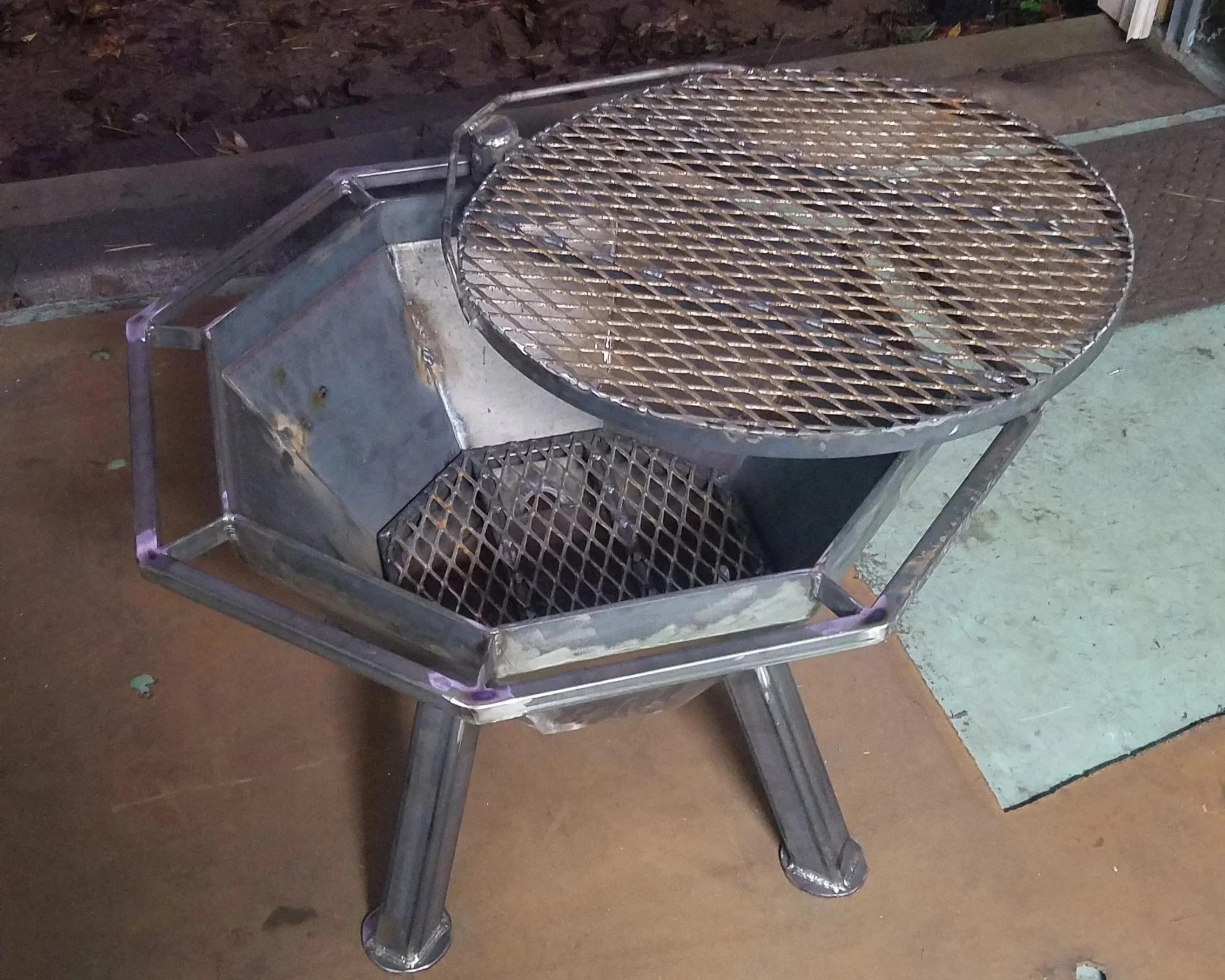 A metal grill with a cooking grate.