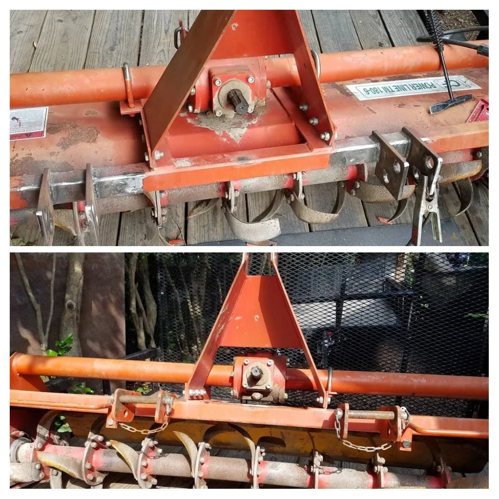 Close-up of a used orange rotary tiller attachment with metal blades, chains, and mounting relocation.