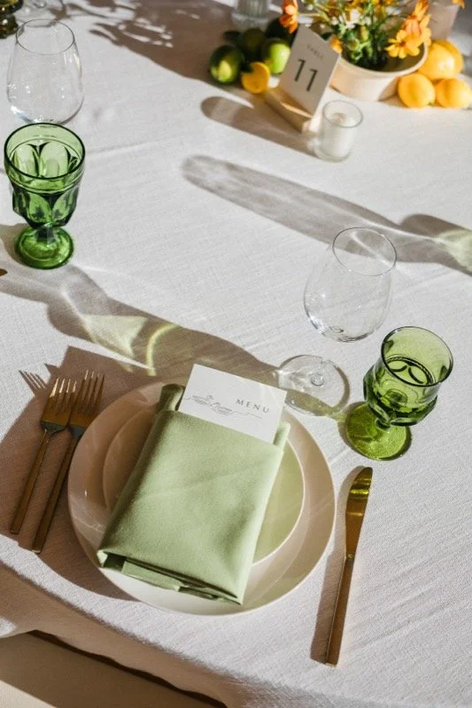 Citrus and green glassware place setting at a Cornerstone Sonoma wedding styled by Events by GS.