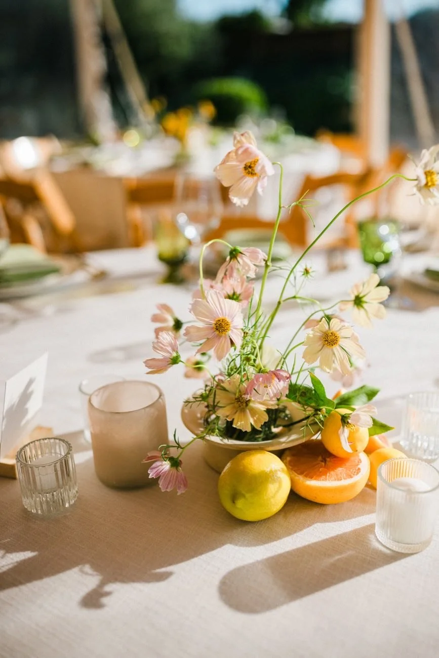 Citrus and floral wedding tablescape designed by Events by GS.