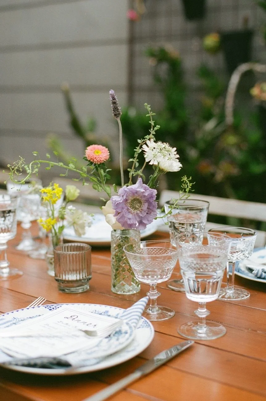 Outdoor garden reception table with floral centerpiece at a wedding designed by Events by GS.