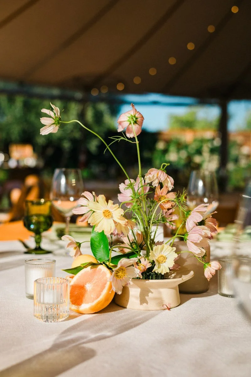 Citrus and floral wedding tablescape designed by Events by GS.