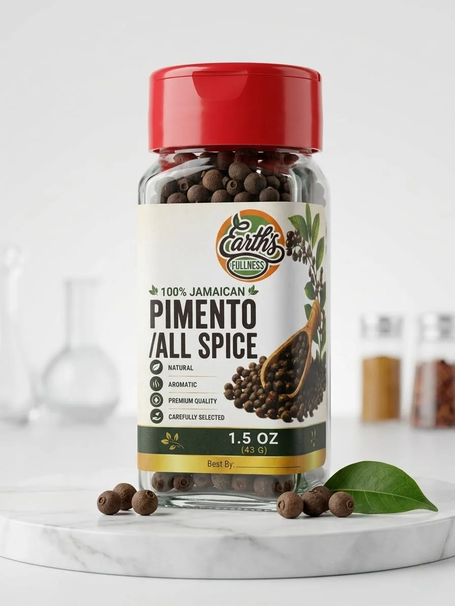 Bottle of Earth’s Fullness Pimento All Spice with some peppercorns and a green leaf in front on a white surface.