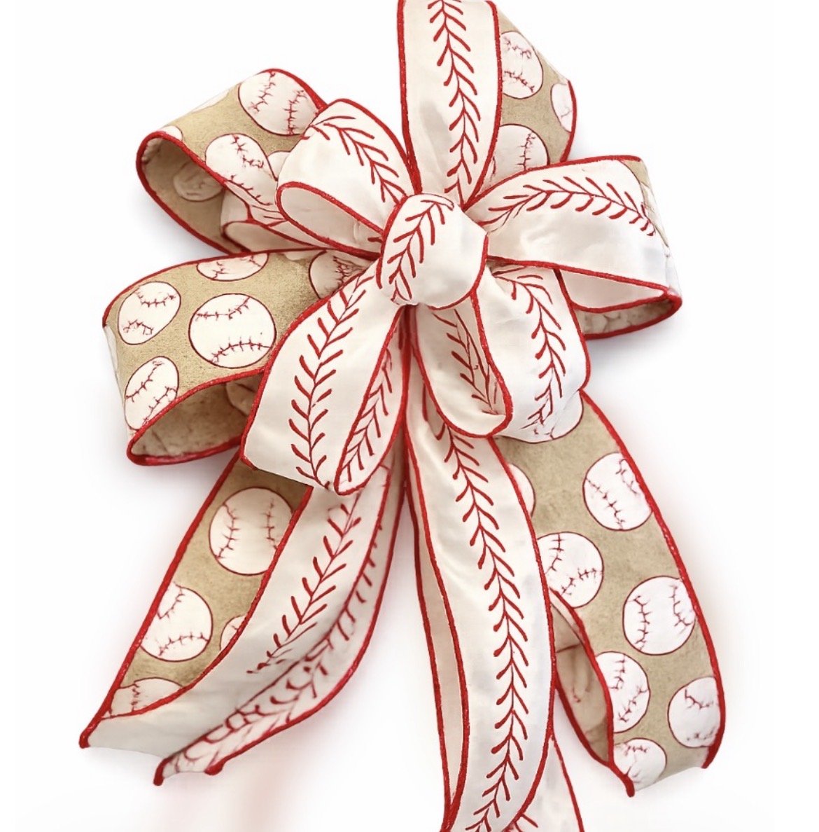 Decorative bow with baseball patterns and red stitching on white ribbon, tied in a multi-looped style.