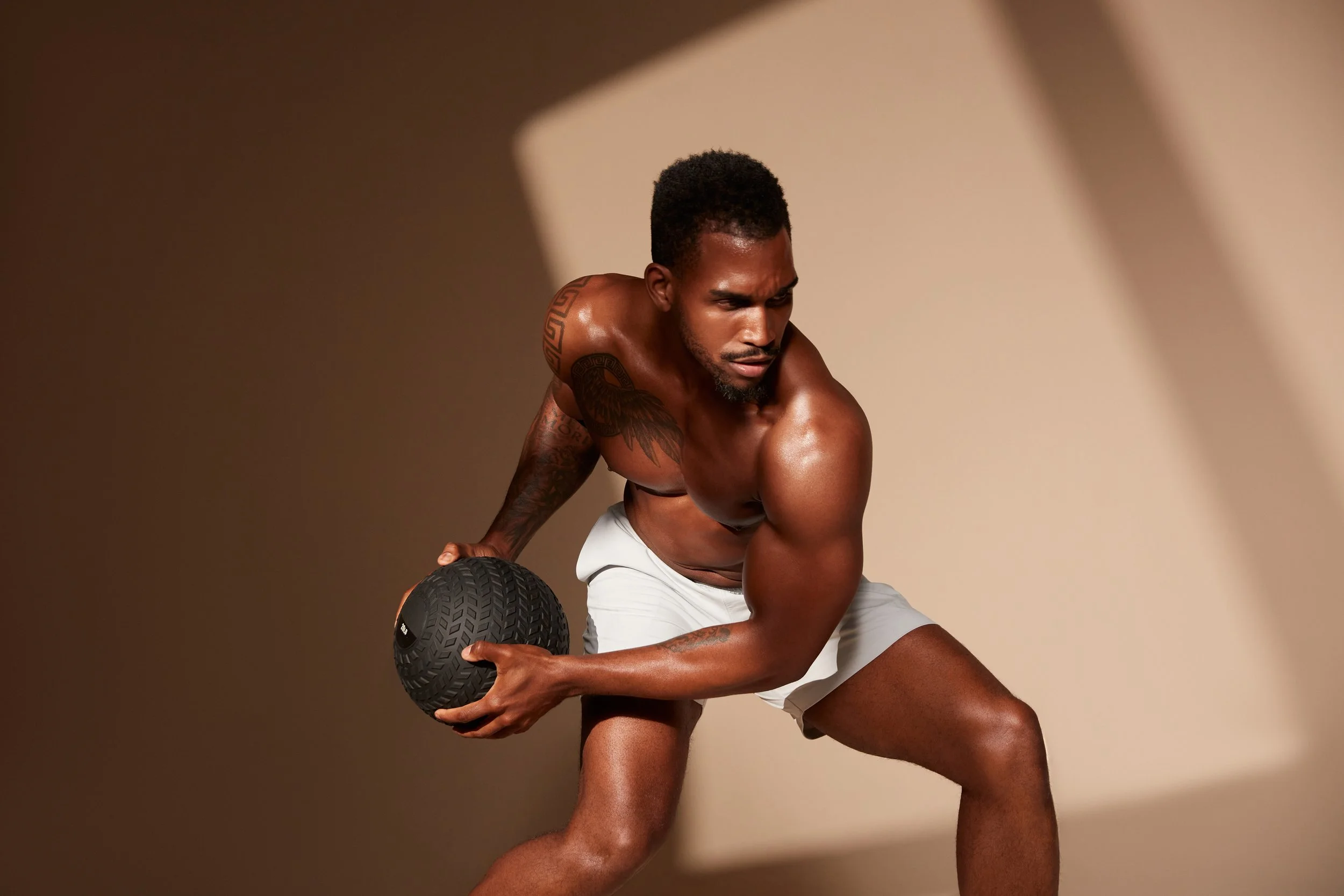 Male doing medicine ball exercise