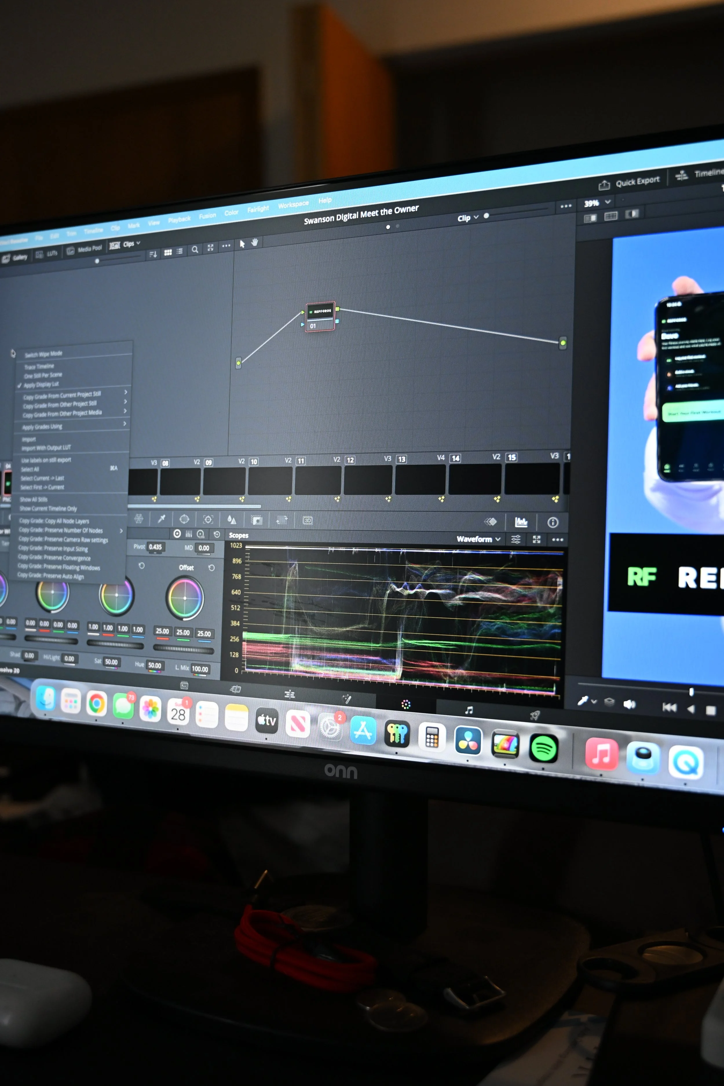 Computer monitor displaying video editing or visual effects software, with waveform graphs and timeline editing tools visible.