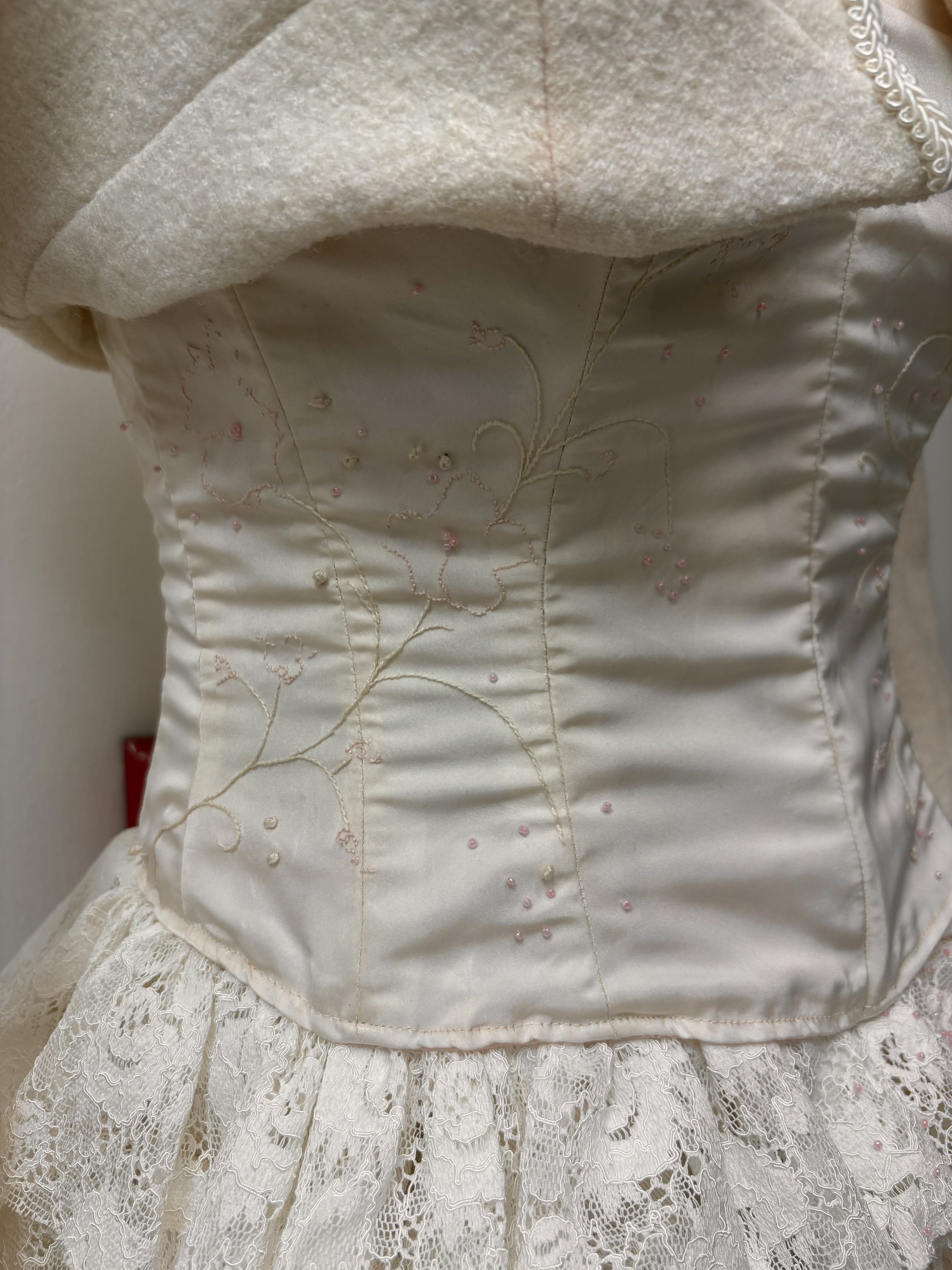 A closeup of the embroidered corset