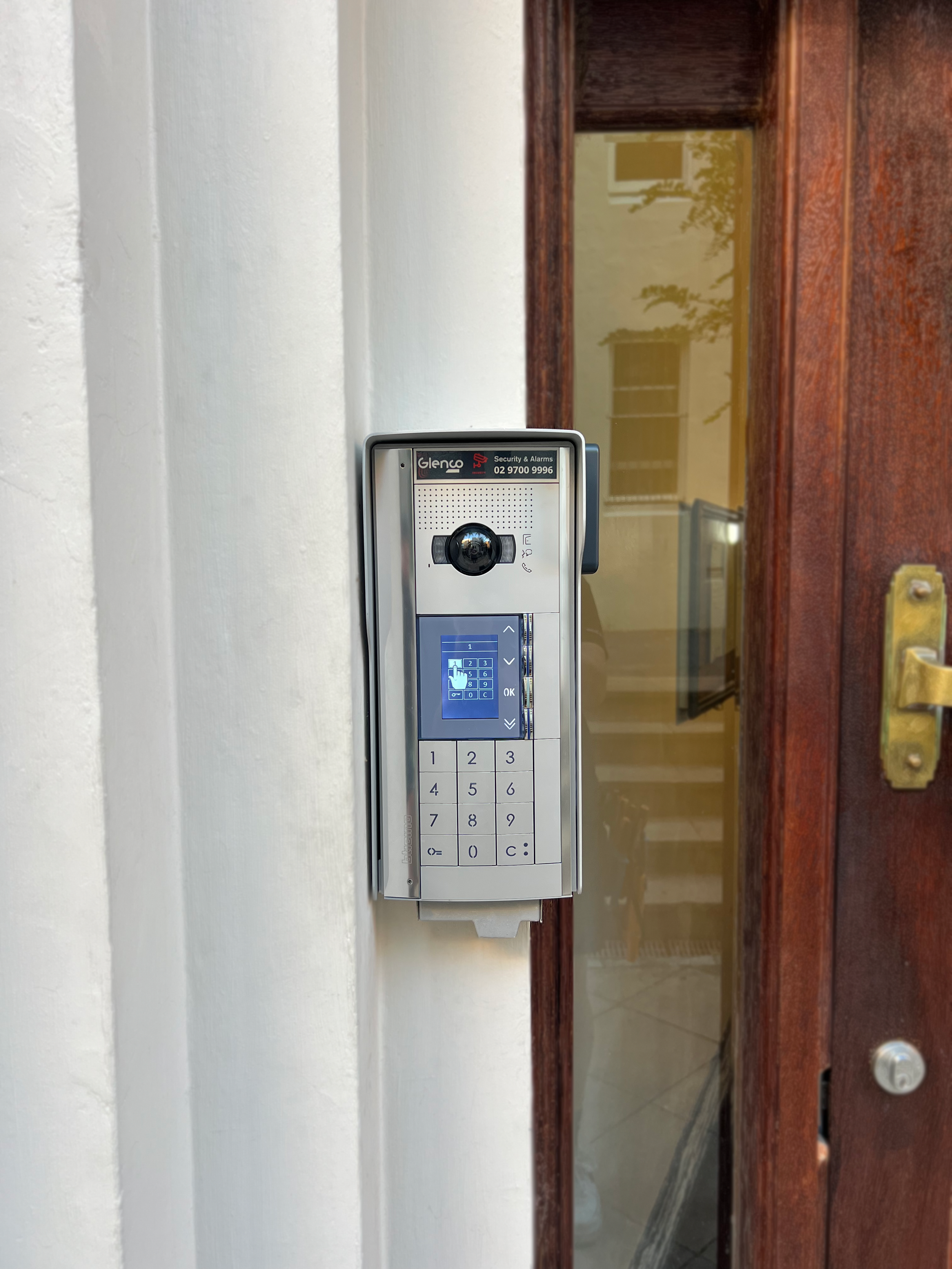 A security intercom mounted on a apartment door