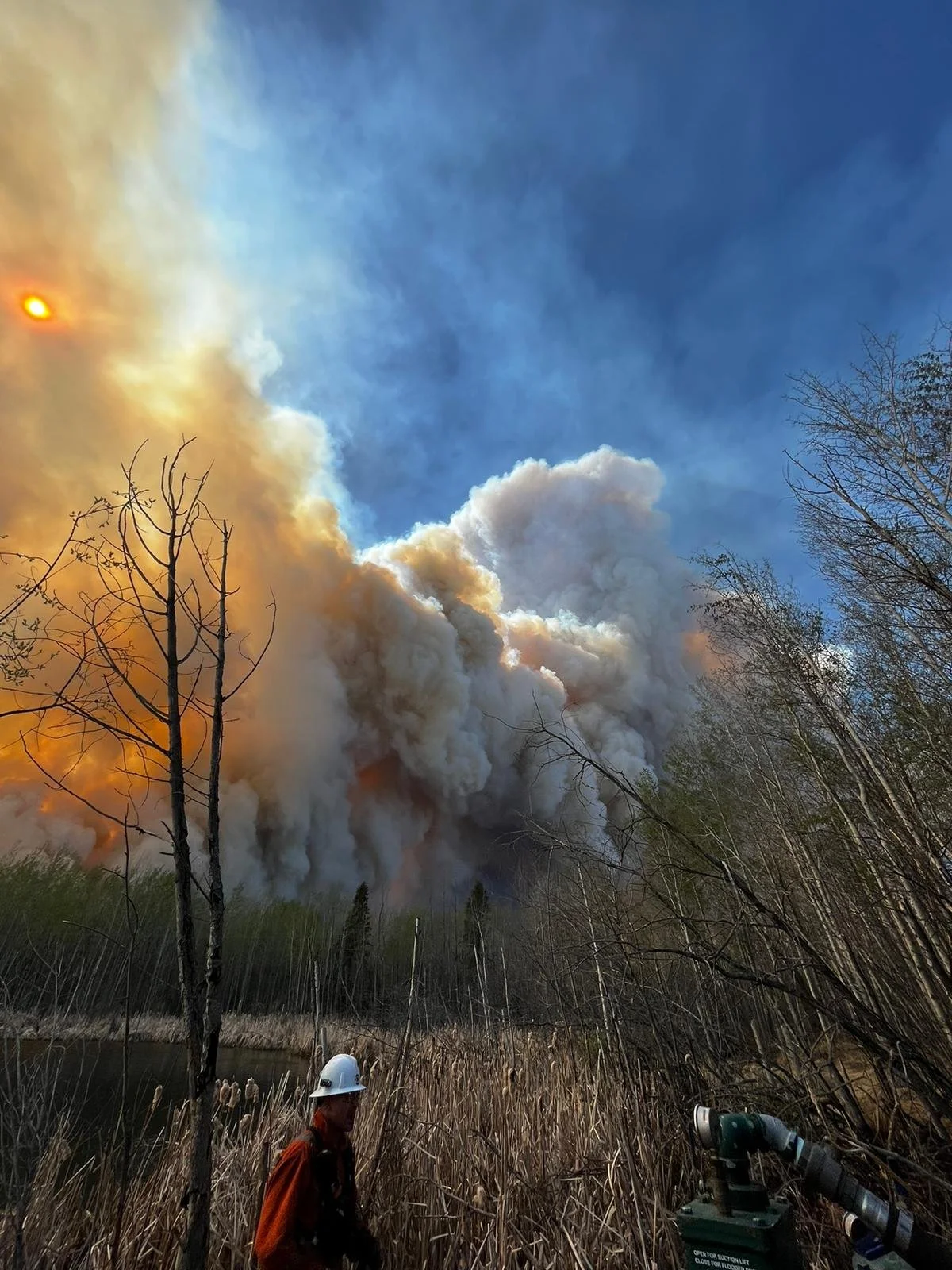 Wildland firefighters responding to an active wildfire in Alberta, providing rapid deployment wildfire suppression and tactical emergency response services.