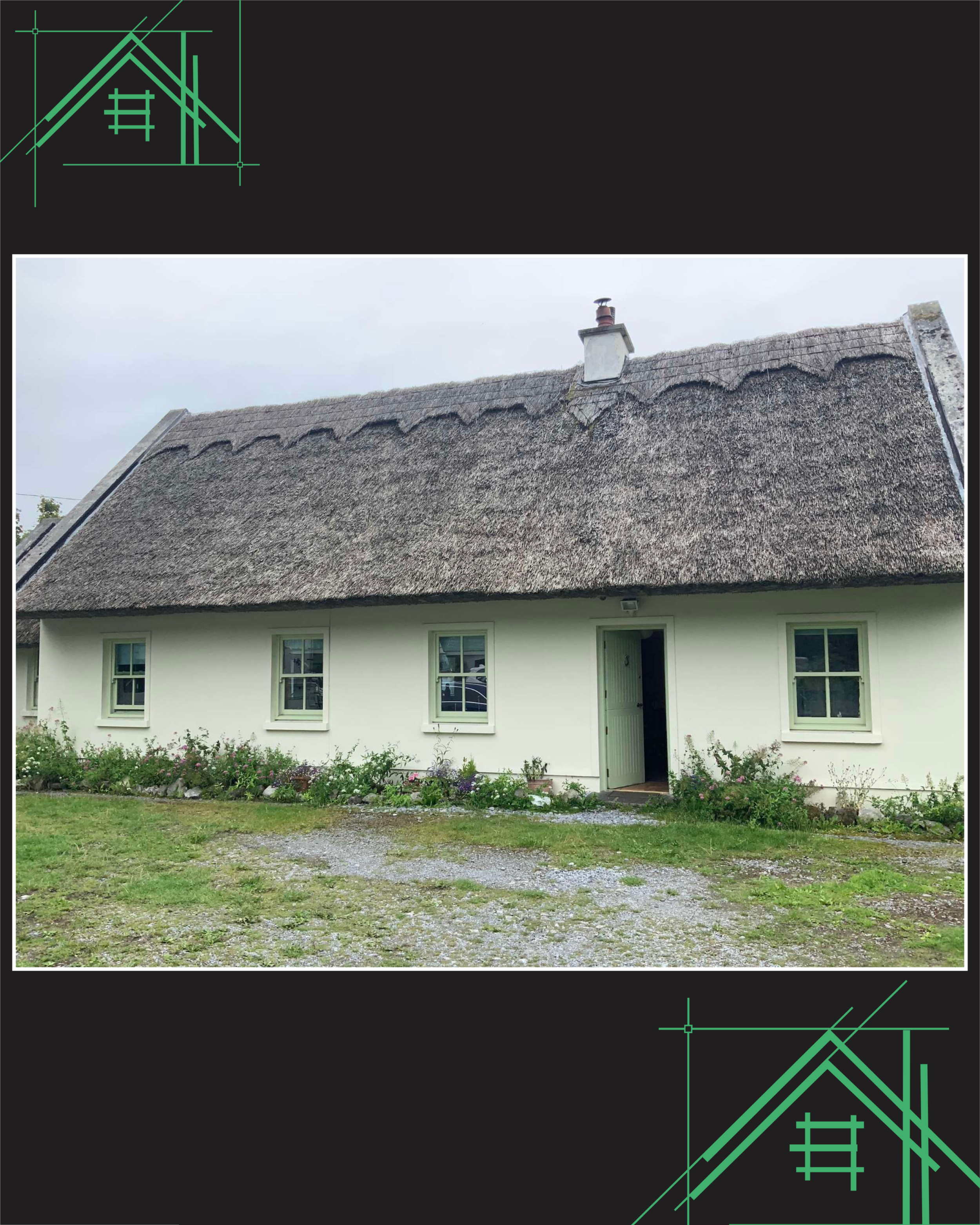 Photo of a house with a steep, textured roof, a chimney, a white main exterior, and a front yard with grass and flowering plants.