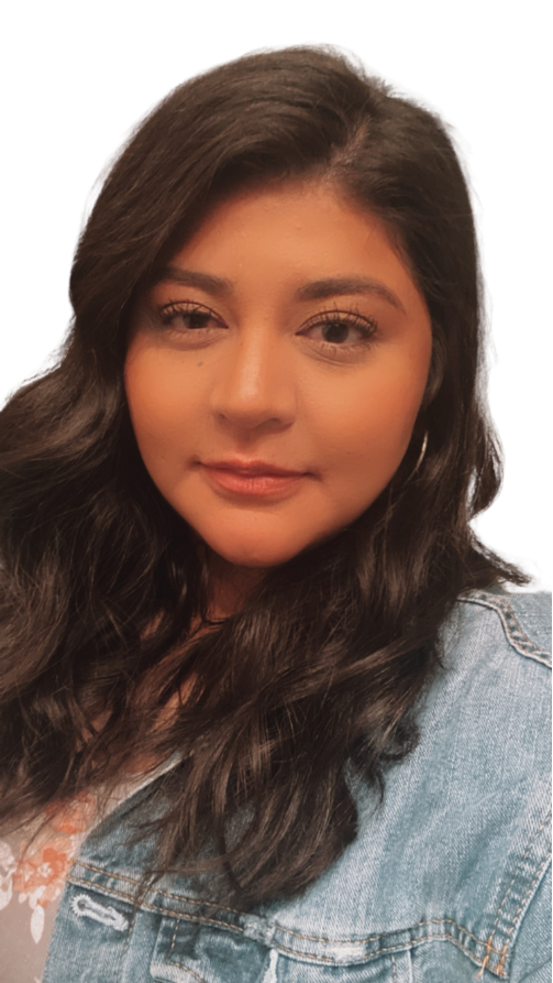 A young woman with long dark wavy hair, wearing a denim jacket, looking at the camera with a slight smile, against a plain white background.