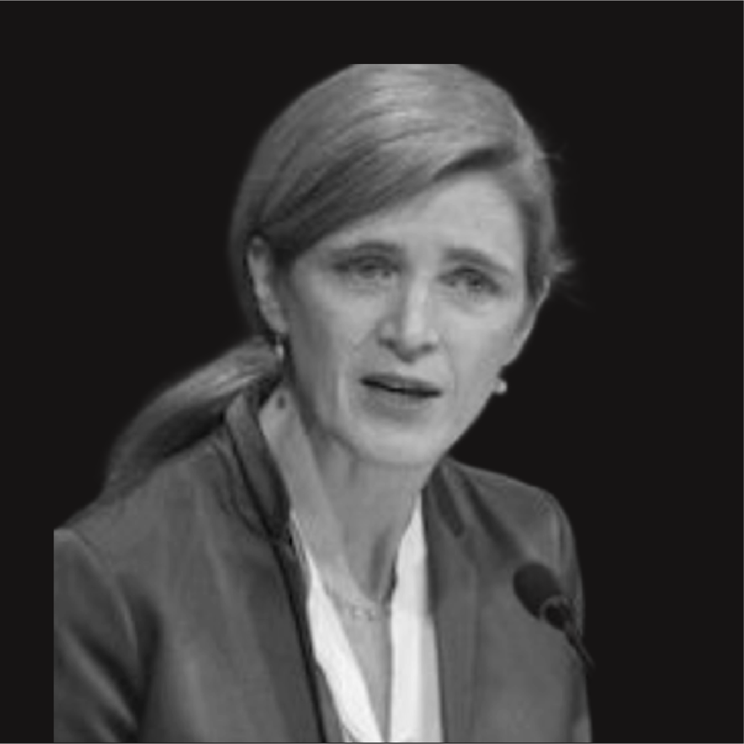 Black and white photo of a woman with shoulder-length hair speaking into a microphone.