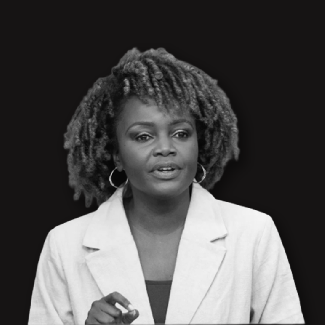 Black and white portrait of an African American woman with curly hair, wearing a light-colored blazer and hoop earrings, against a dark background.