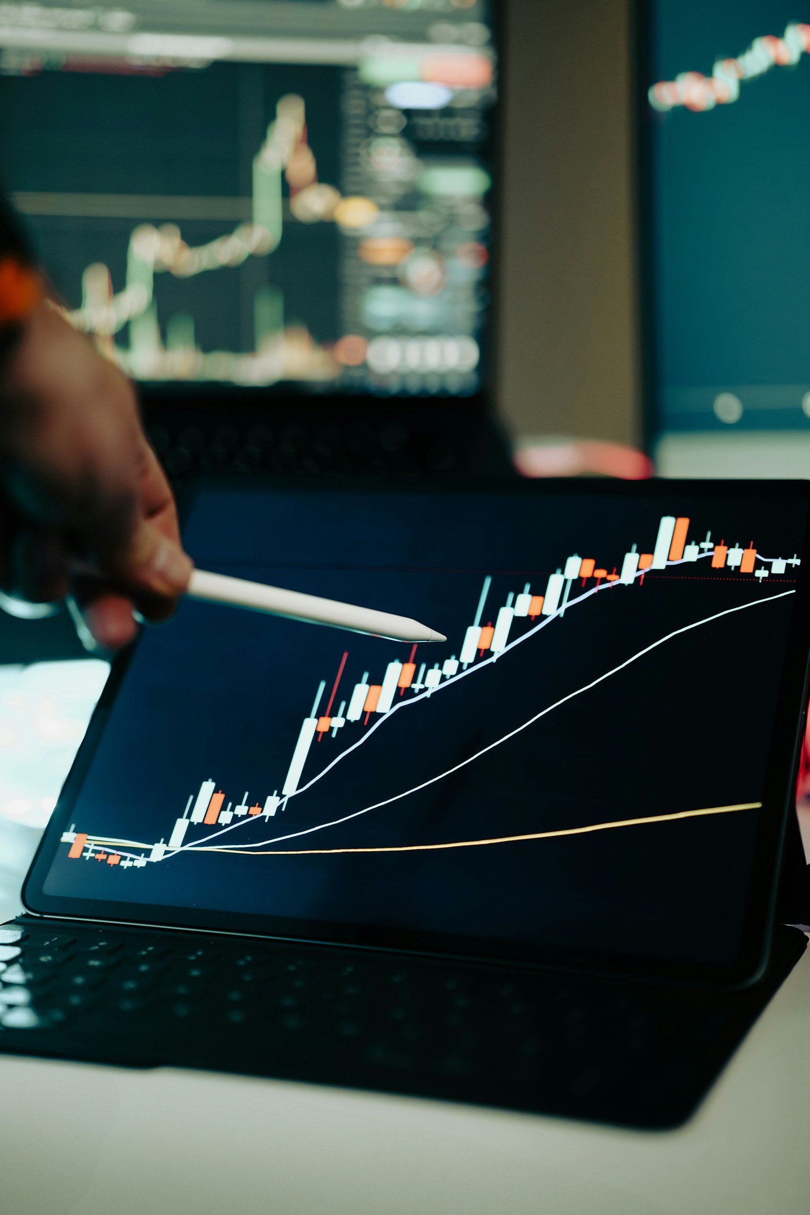 A computer screen displaying a financial trading chart with candlestick patterns and moving average lines.
