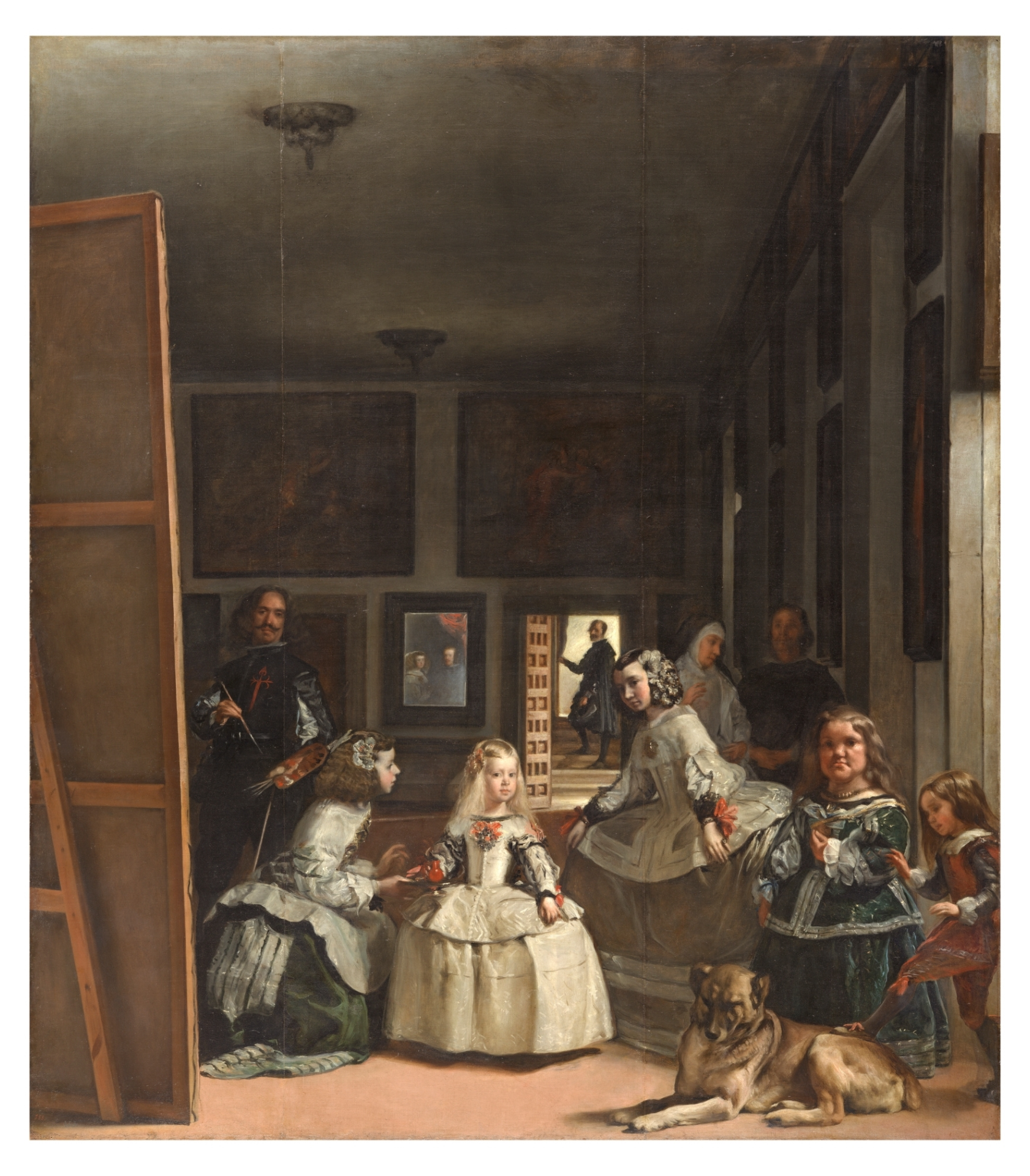 A group of children and a woman in a painting, with a large mirror reflecting artwork, and a dog lying on the floor in front of them.