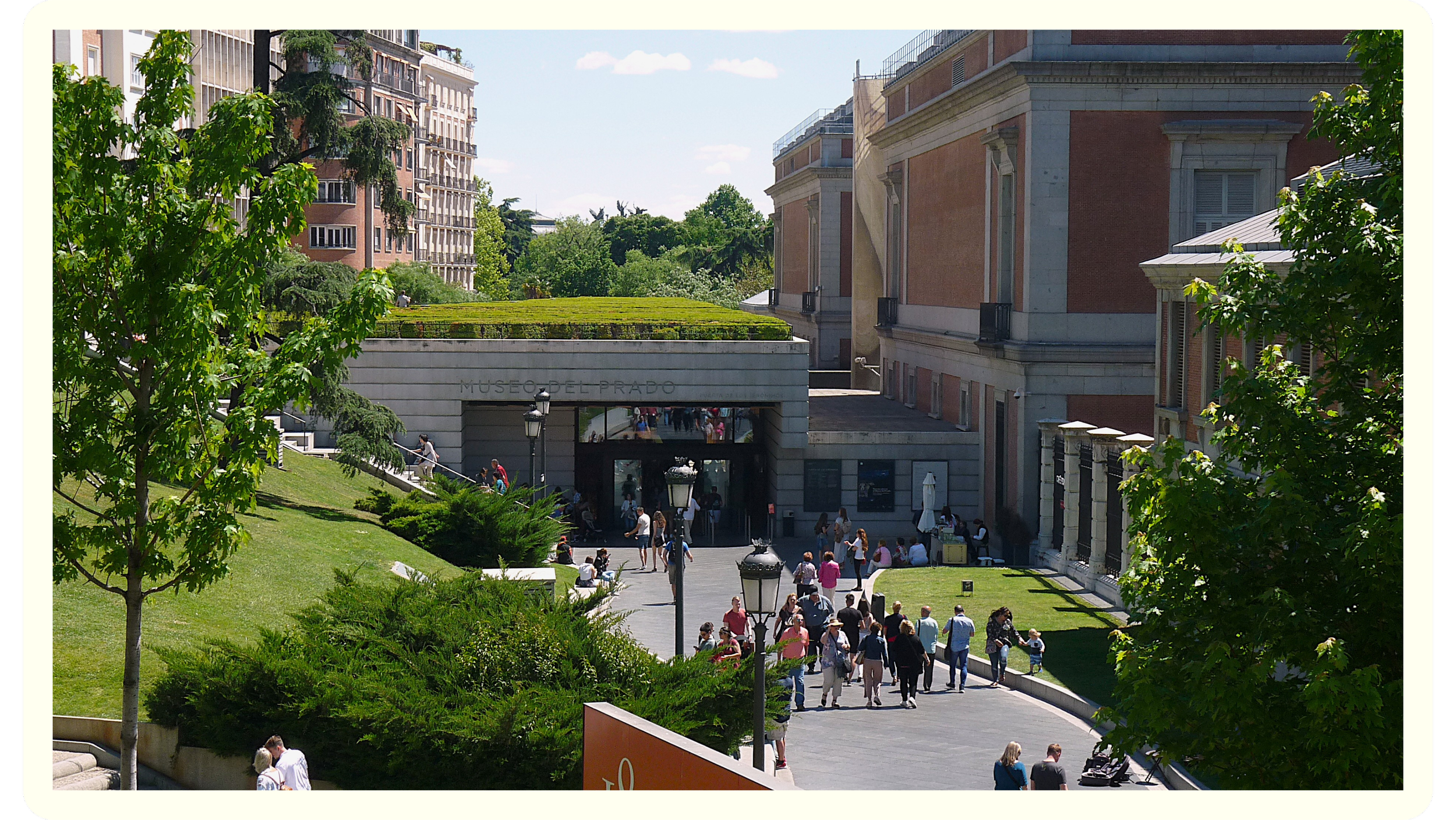People walking into and around the Museo del Prado in Madrid, Spain, surrounded by green trees and classical architecture on a sunny day.