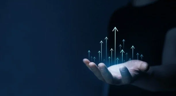 A person's hand with digital upward arrows emerging from the palm, symbolizing growth or technology.