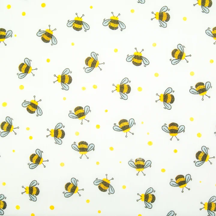 Pattern featuring cartoon bees and yellow dots on a white background.