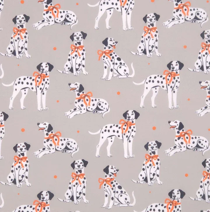Pattern of Dalmatian dogs with orange bows on a gray background.